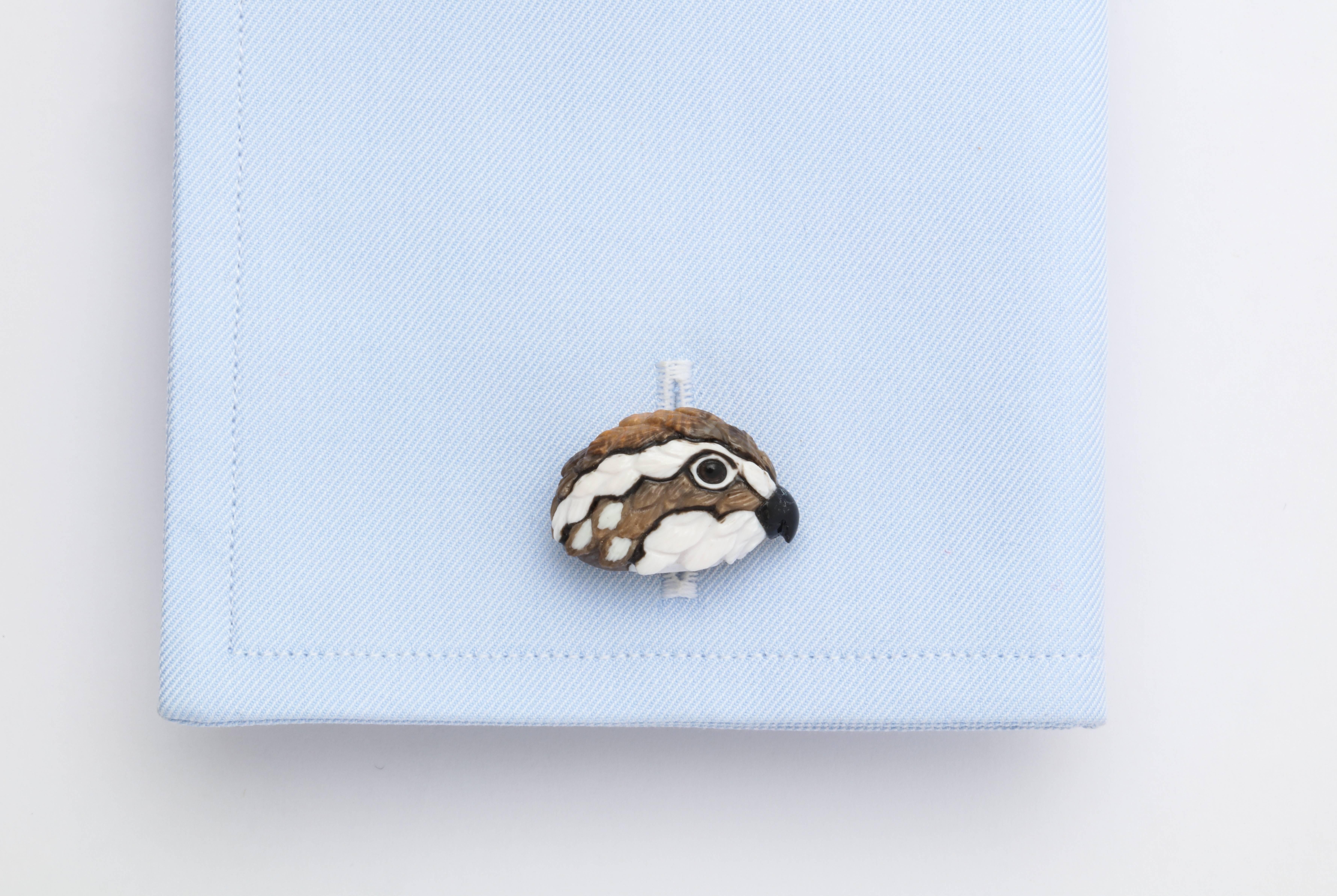 These wonderful cufflinks truly exemplify the artisanal process of intarsia, which is the artistic assembly of decorative materials.  In this case each carving is the combination of 9 stones, including fossilized wood, cocholong, black tourmaline