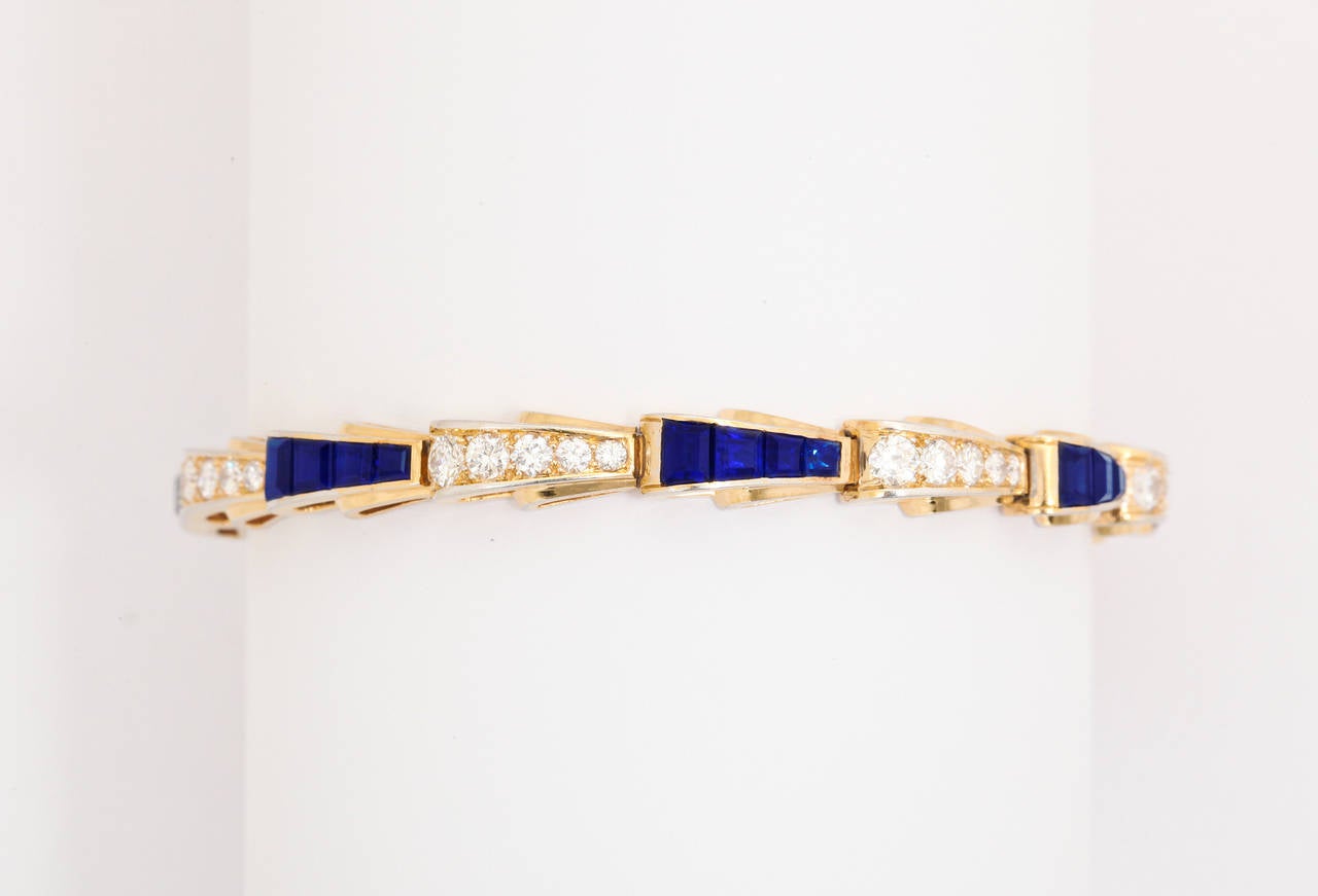 An exquisite, and very finely made, sapphire and diamond bracelet.  Although unsigned, this piece certainly portrays the work of a fine jeweler.  The sapphires have been custom cut into four different sizes to fit this specific design,  The diamonds