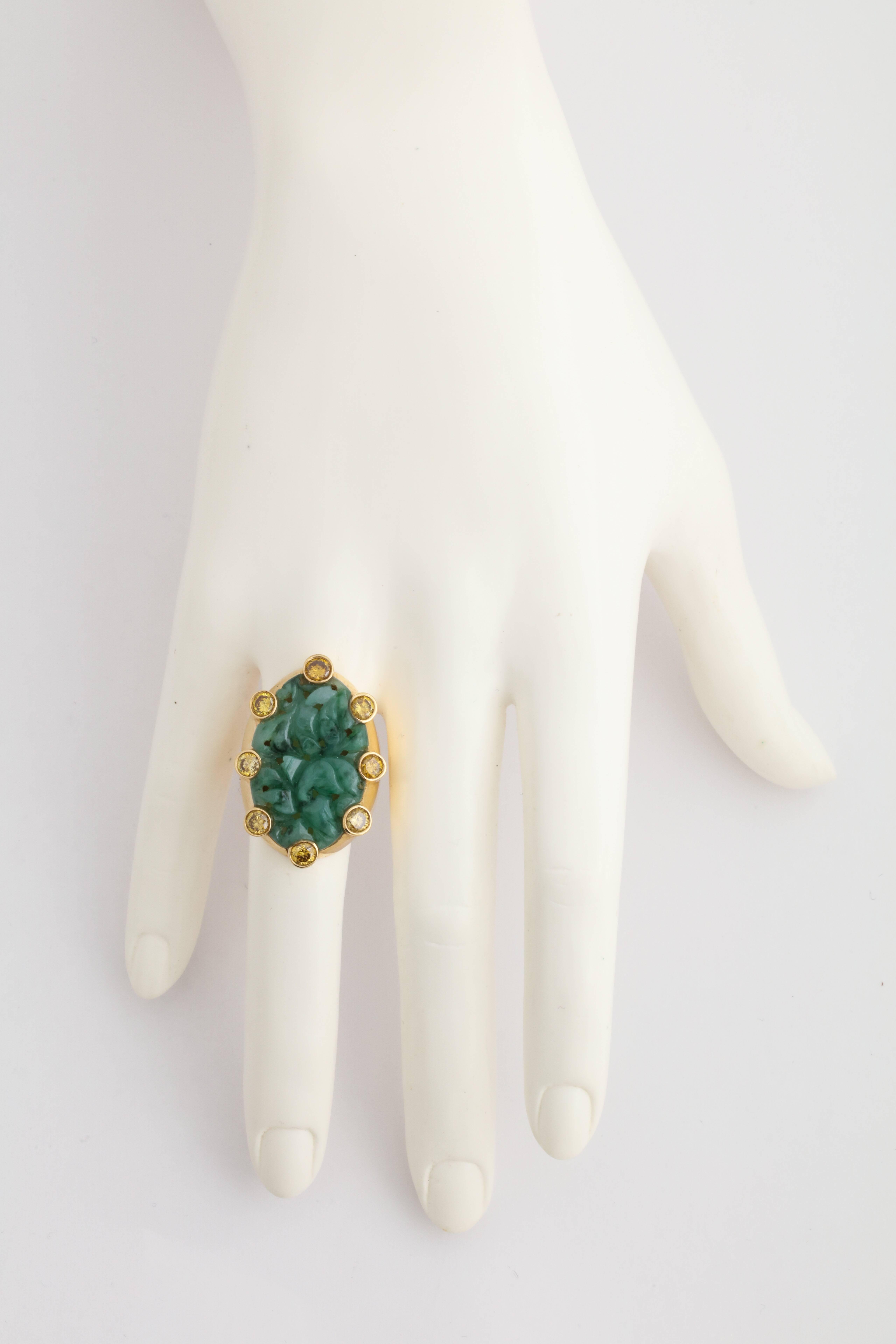 A truly one of a kind piece by a one of a kind designer.  Cooperman expertly combines these two contrasting materials.  The softness of the delicately carved sea green jade is offset by the bursting brilliance of the faceted yellow diamonds.  All