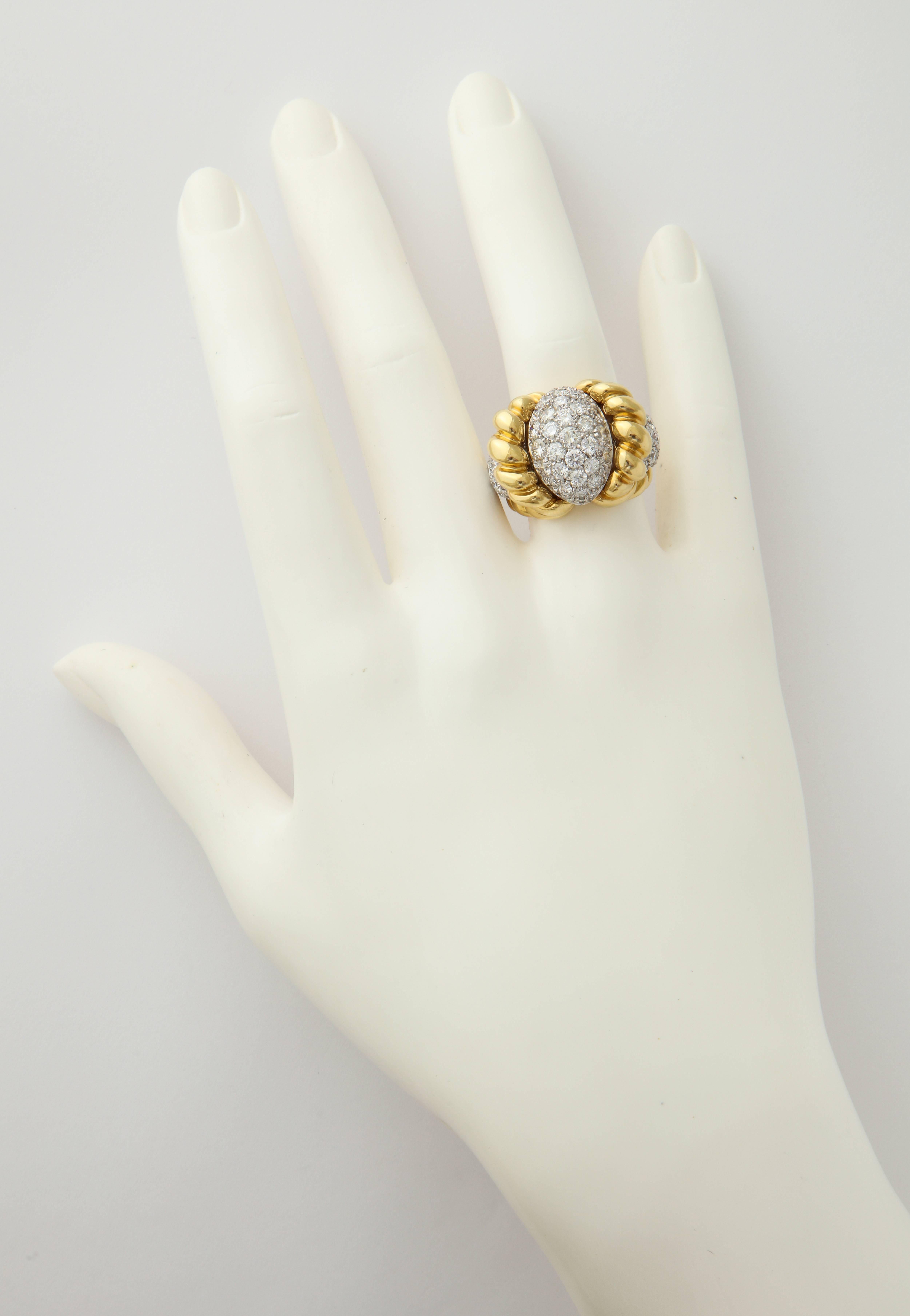 The perfect mixture of yellow and white gold set with bright, white diamonds truly epitomizes the term "cocktail ring".  This one was made in Italy and is set with 3.88cts of diamonds.  The ribbed, polished gold motif perfectly frames the