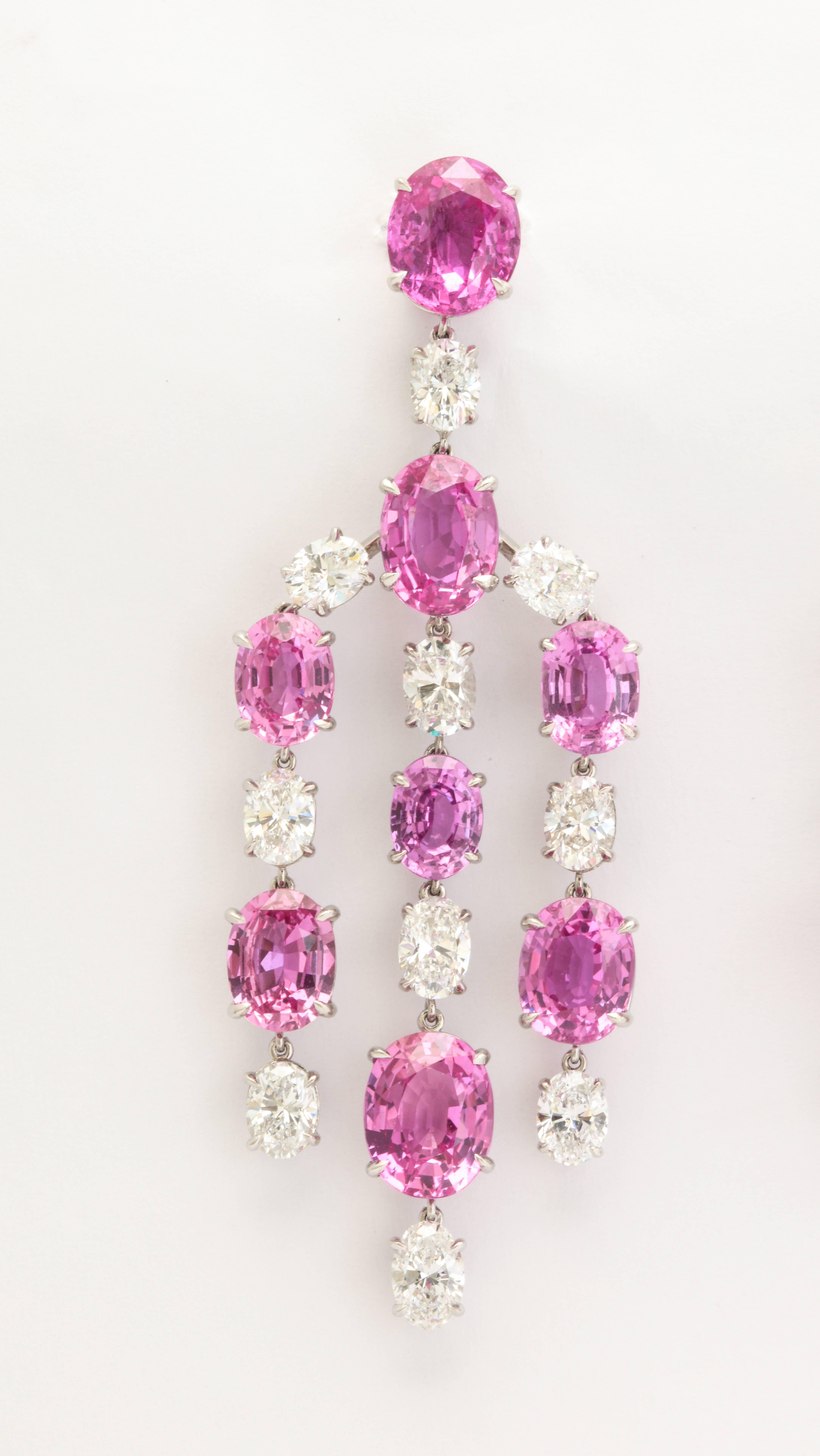 Elegant, and opulent, these wonderful chandelier earclips feature 16 vibrant, pink sapphires (37.20cts total weight) expertly set with the whitest of white diamonds.  The seventeen oval diamonds weigh a total of 7.61cts with three of them weighing