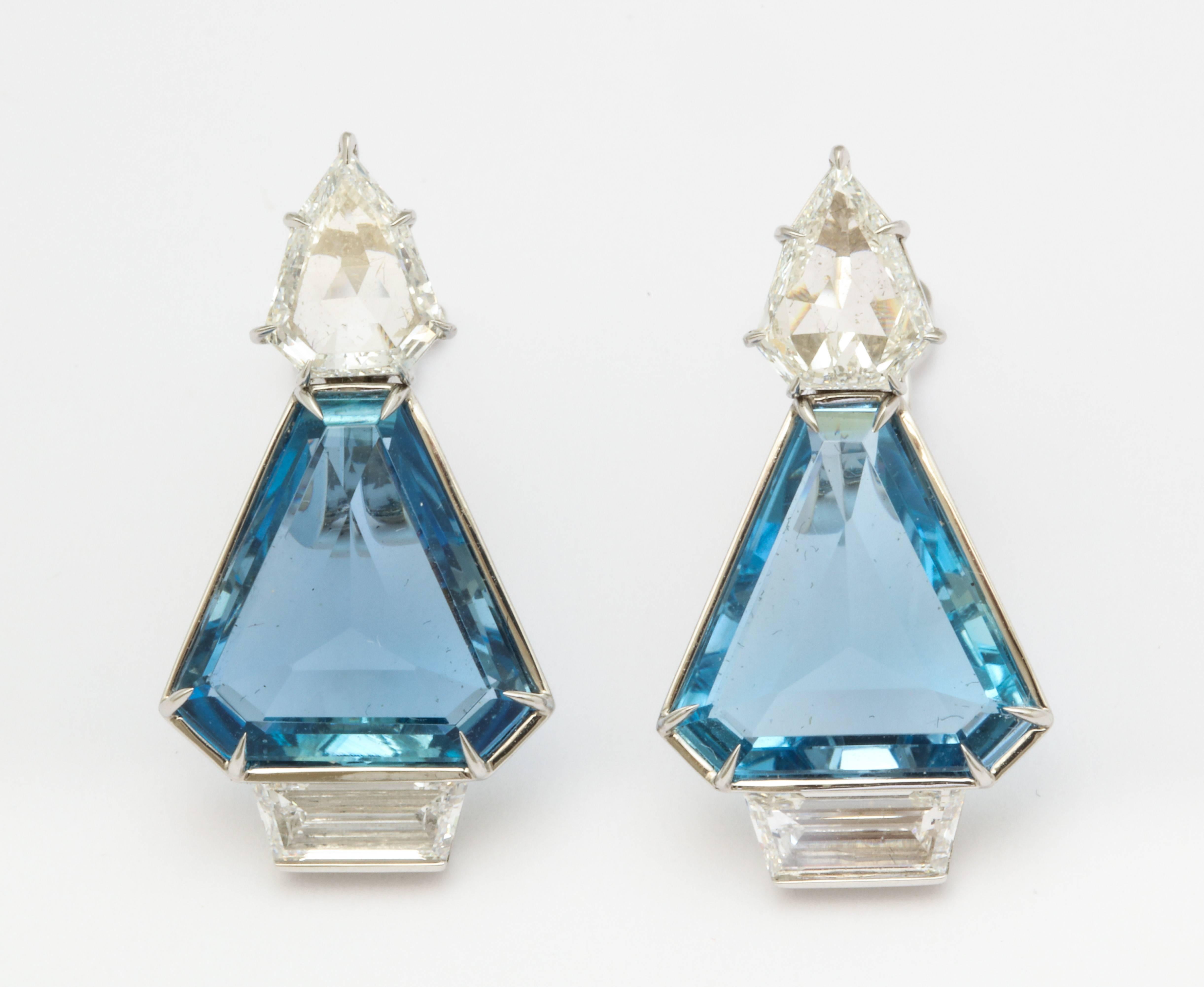 These one of a kind earclips feature a perfectly matched pair of aquamarines, weighing a total of 7.37cts.  They are cut as shield shapes, which are rarely seen and emphasize the truly beautiful color of the stones.  Completing the design are two