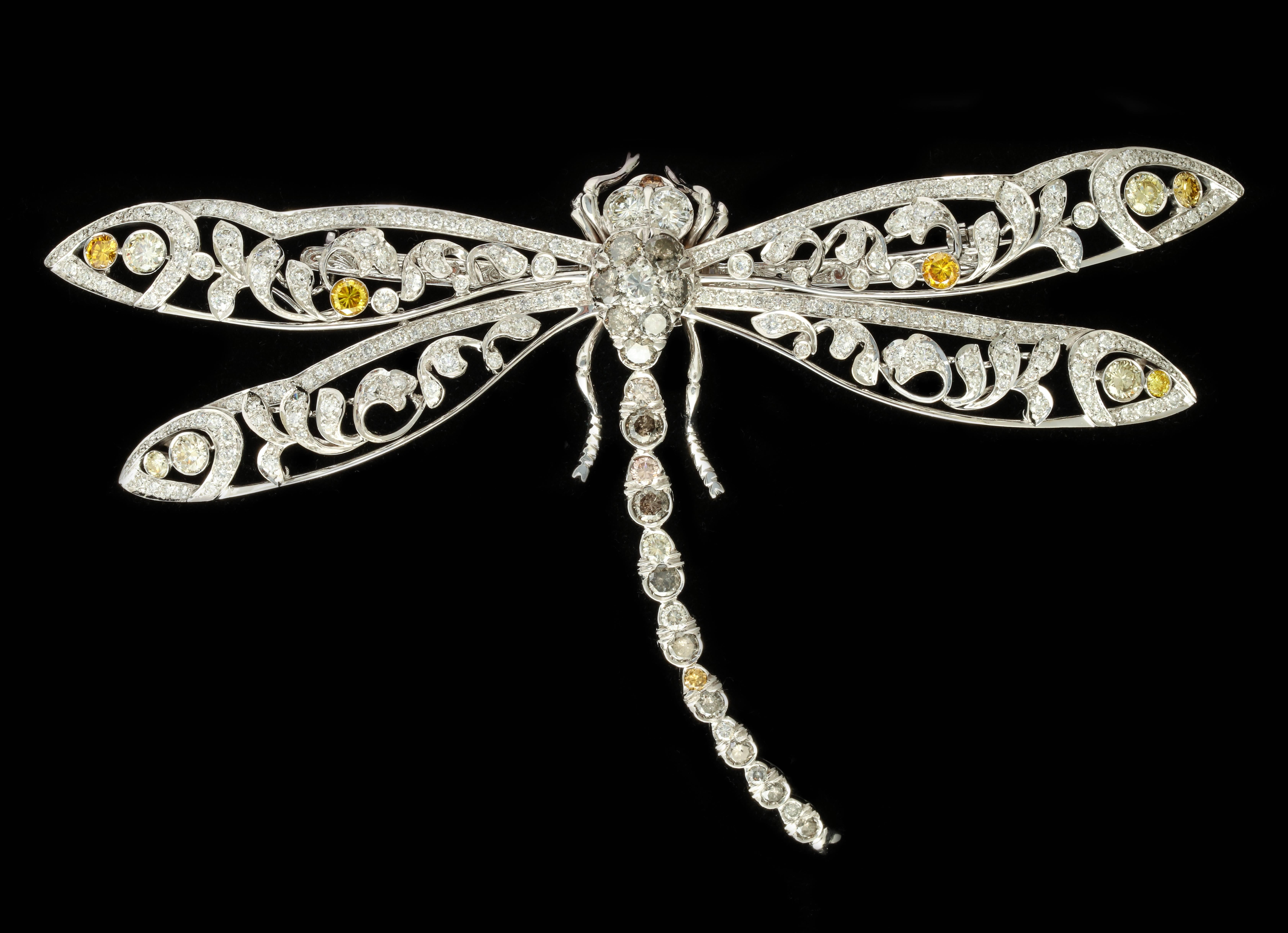 This stunning dragonfly is bold in size, yet light and delicate thanks to the intricate openwork design.  The 10cts of diamonds include bright, white stones as well as some shades of brown, grey and some treated yellows.  The combination is as