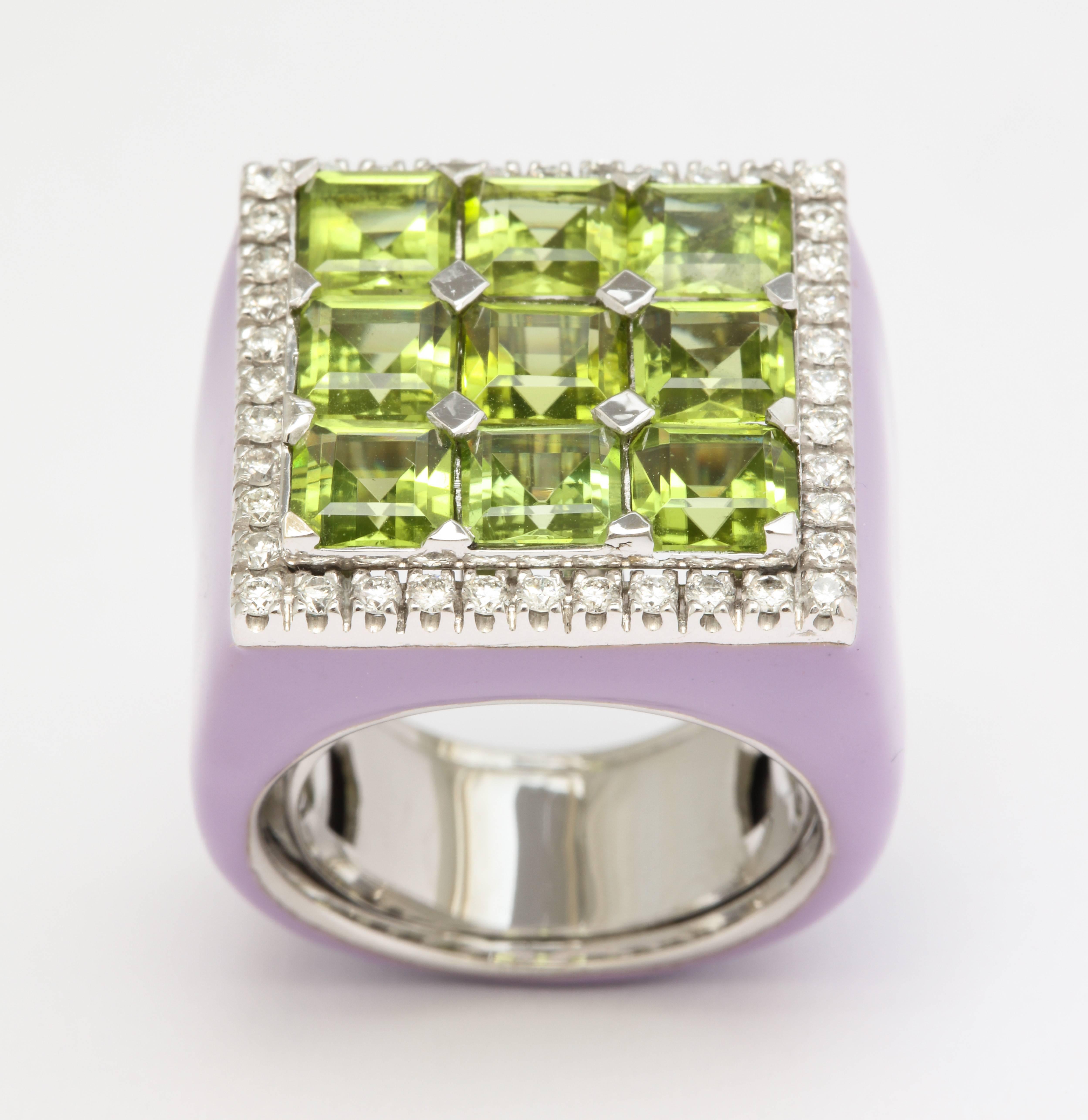 A touch of color is always nice, so a burst of color should be that much better.  The nine square cut peridots provide this burst, while they are framed by bright, white diamonds and set into a wonderful purple enamel ring.  
Diamonds: