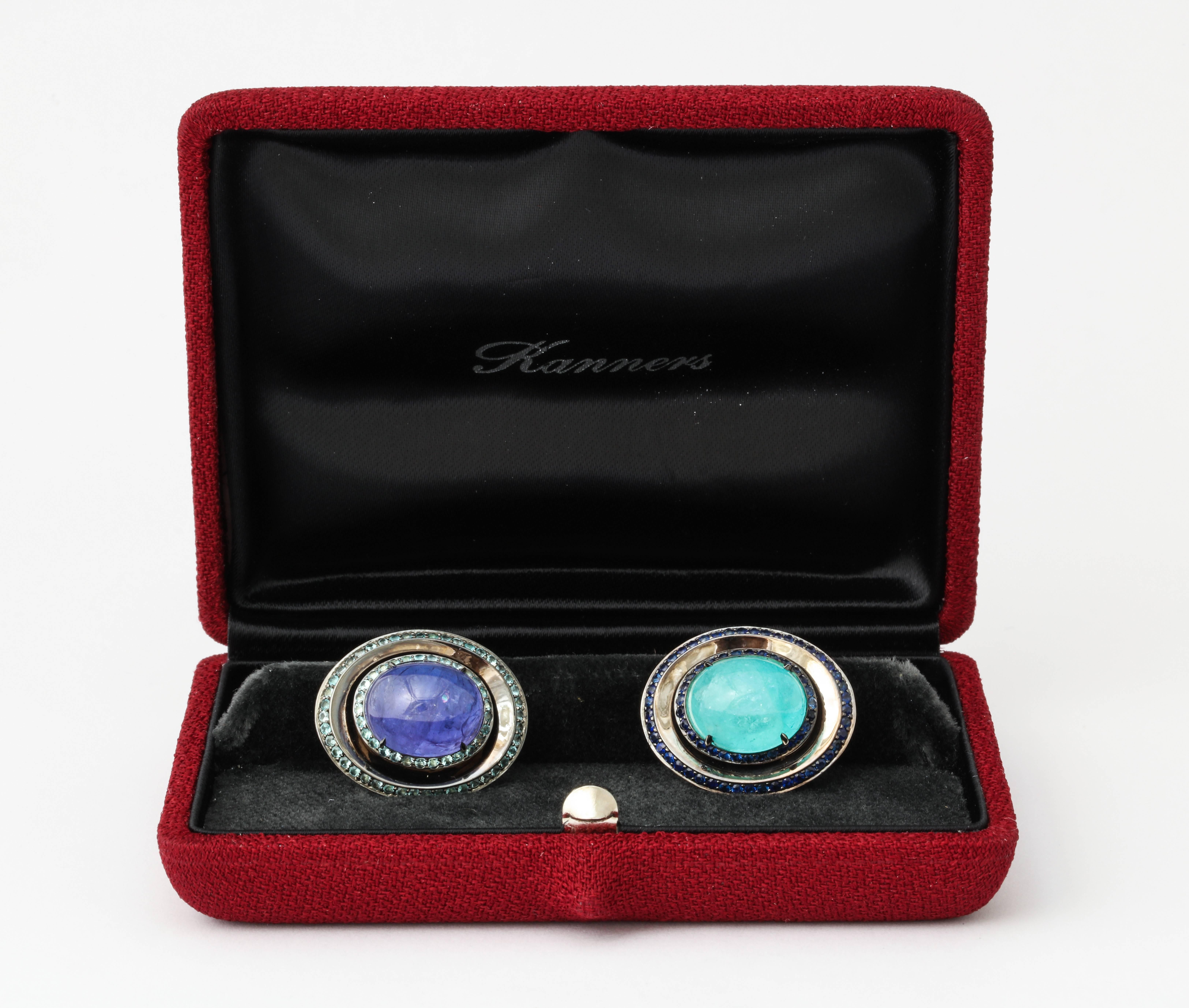 Uniquely sourced and cut to match stones, combined with meticulous craftsmanship- this is the true meaning of one of a kind, and these cufflinks are just that.  The center stones are a Brazilian Paraiba tourmaline weighing  7.54cts and a Tanzanite
