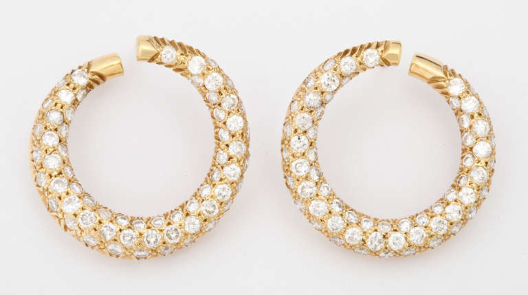 Forever stylish, and always wearable, these are the perfect size hoop earrings to be worn from day into evening.  Measuring an elegant one inch in diameter, they are packed with app. 5cts of beautifully, brilliant white diamonds.

From a family of