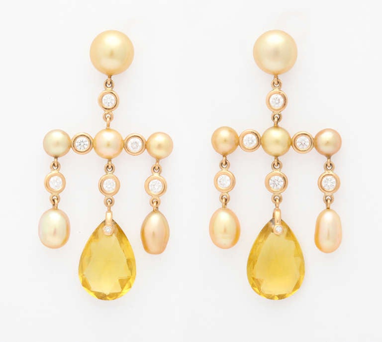 These wonderful earrings are expertly mounted, completely by hand, to maintain a balance and delicacy rarely found in today's jewelry.  Each golden pearl is carefully chosen for it's color and shape to match within the group, which is no easy task