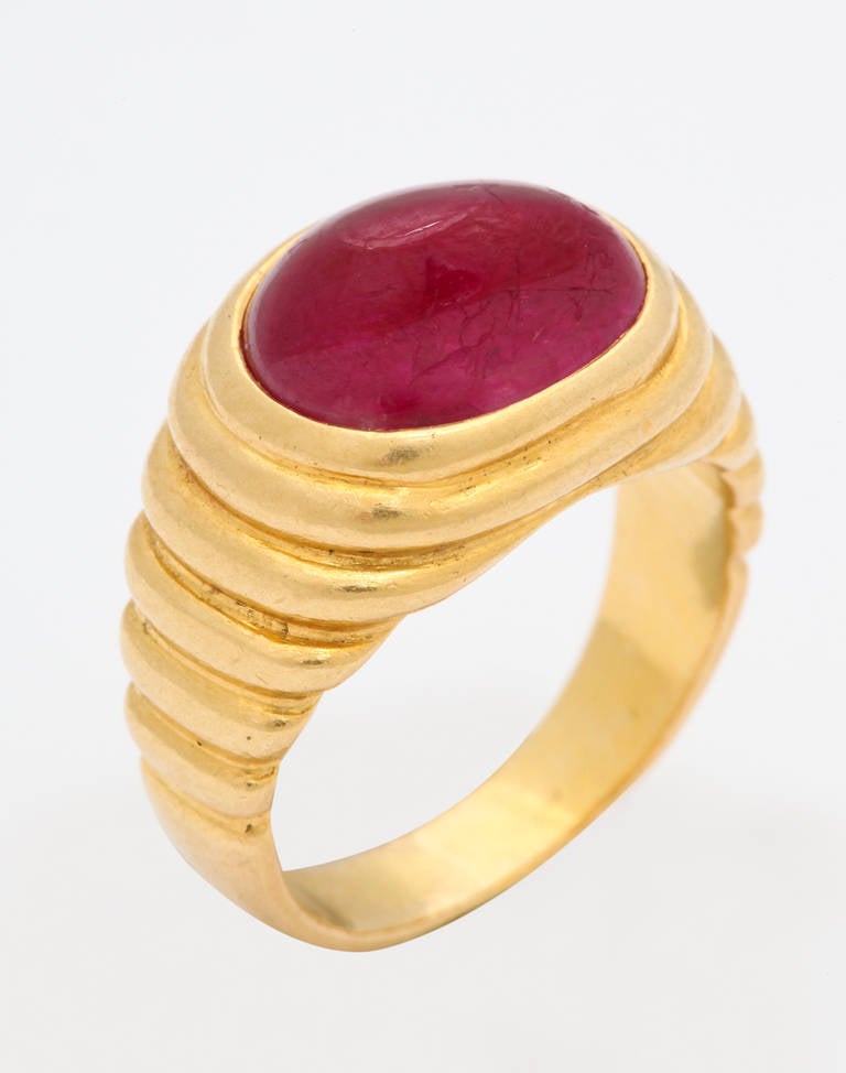 A bright red gumdrop of a stone is bezel set in this stylish 20kt gold ring by Bulgari.  Casually chic, this is a ring to be enjoyed and worn often.  Size 5 1/4.