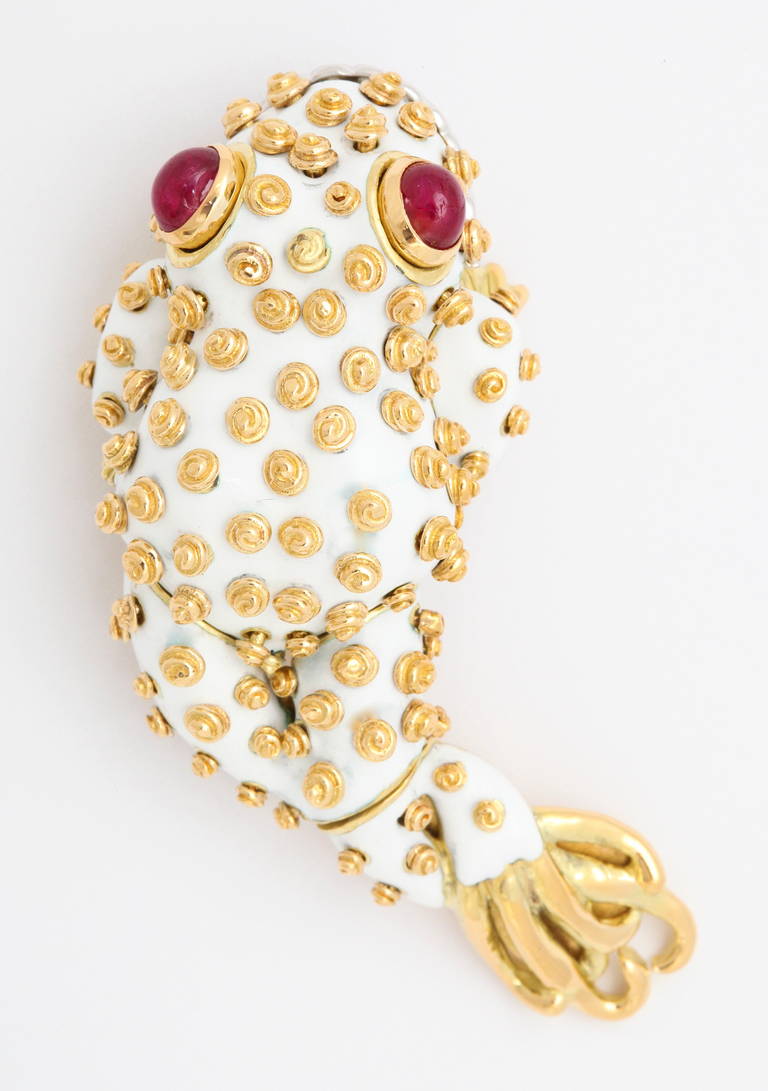 Designed in 1964, this brooch is referred to as the leapfrog, due to the extended rear legs.  The beautiful white enamel is in perfect condition and the bright red ruby eyes and diamond lips render this luxurious frog absolutely unique.

For
