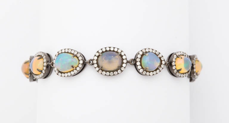 18kt blackened gold, opal (13=app. 8cts) and diamond (app. 2cts) bracelet.  The blackened gold creates a dramatic contrast against the multicolor opals and diamonds.  Unique, stylish and easy to wear.

From a family of jewelers dating back to
