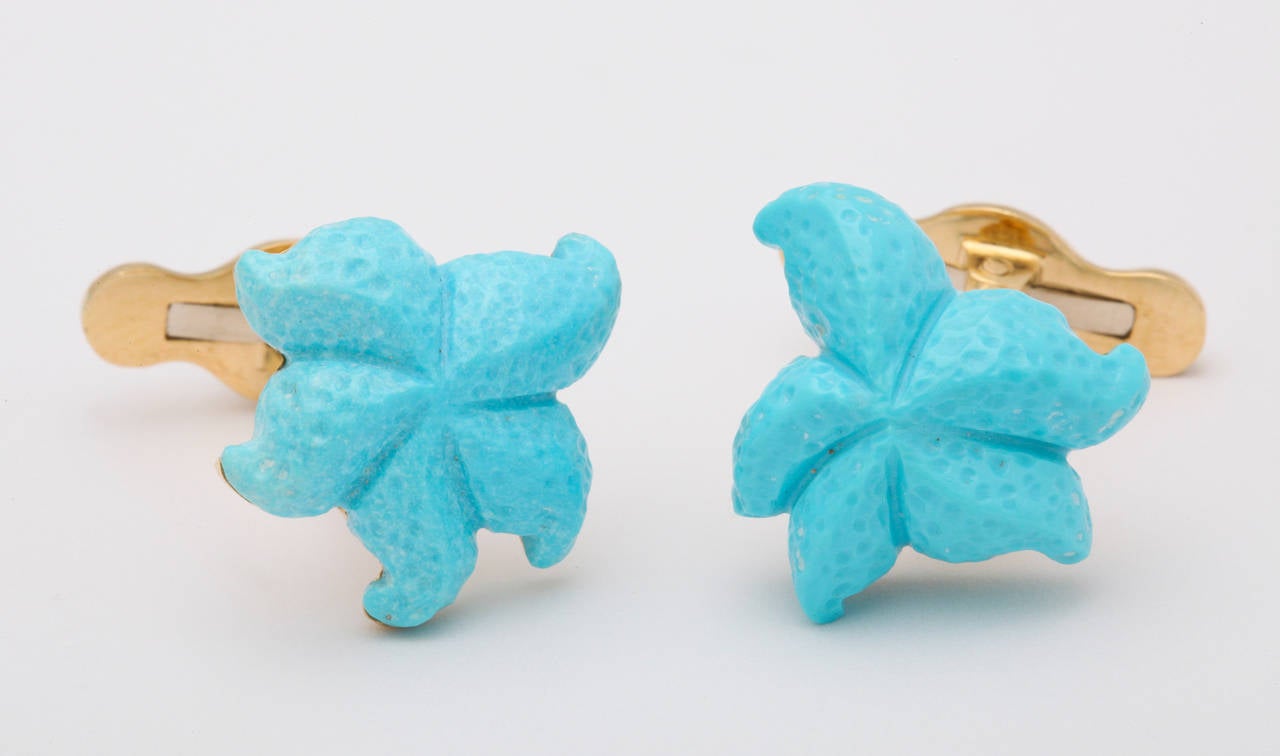 Expertly carved from the finest, bright blue turquoise, these cufflinks are truly one of a kind.  Mounted in 18kt gold with a touch of blue enamel on the spring back.

Cufflinks designed by Michael Kanners are known the world over for their