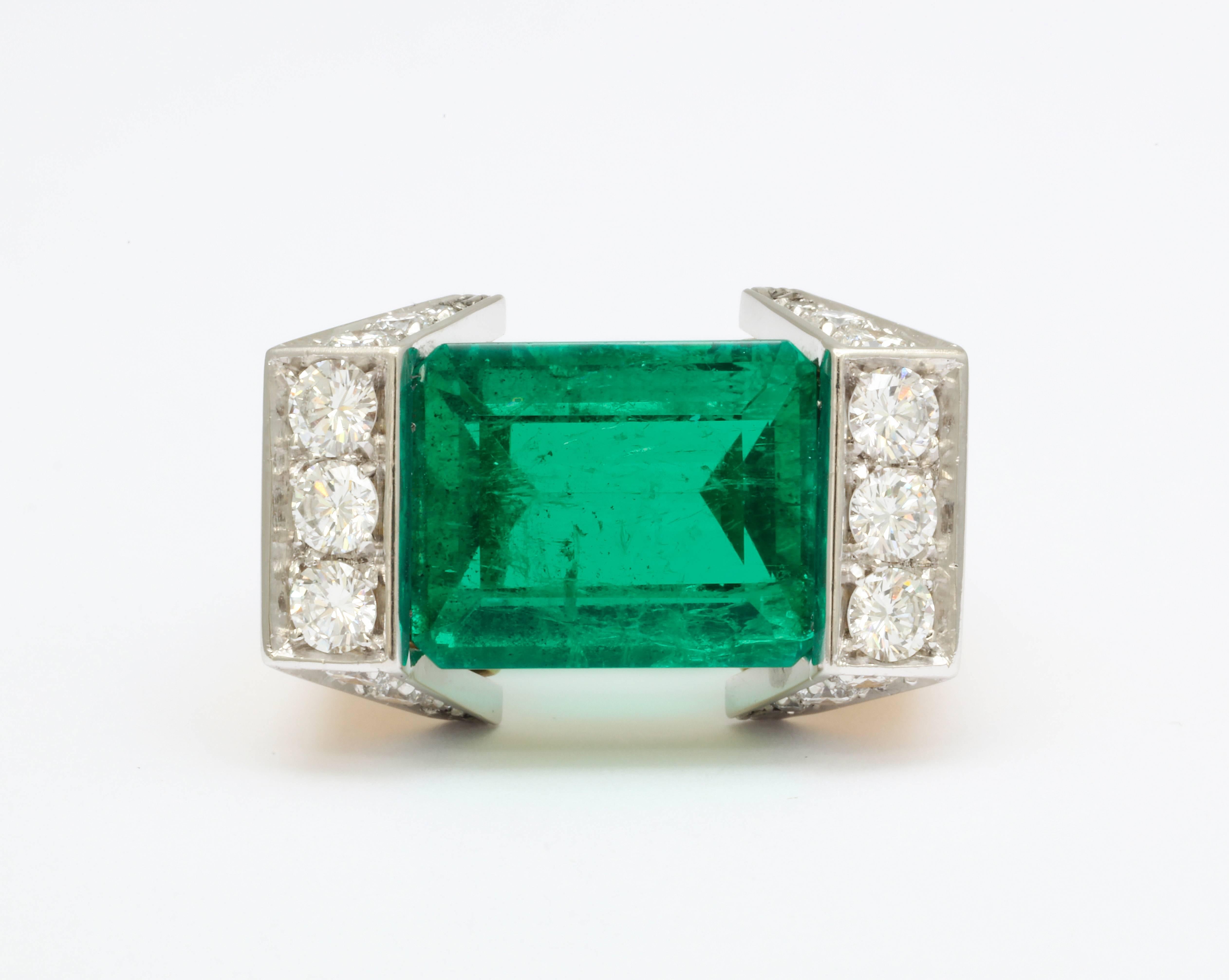 The perfectly rectangular emerald is uniquely set horizontally across the finger, creating a bold and modern look.  The combination of platinum and yellow gold further serves to clearly define each component of the ring.  With full certification