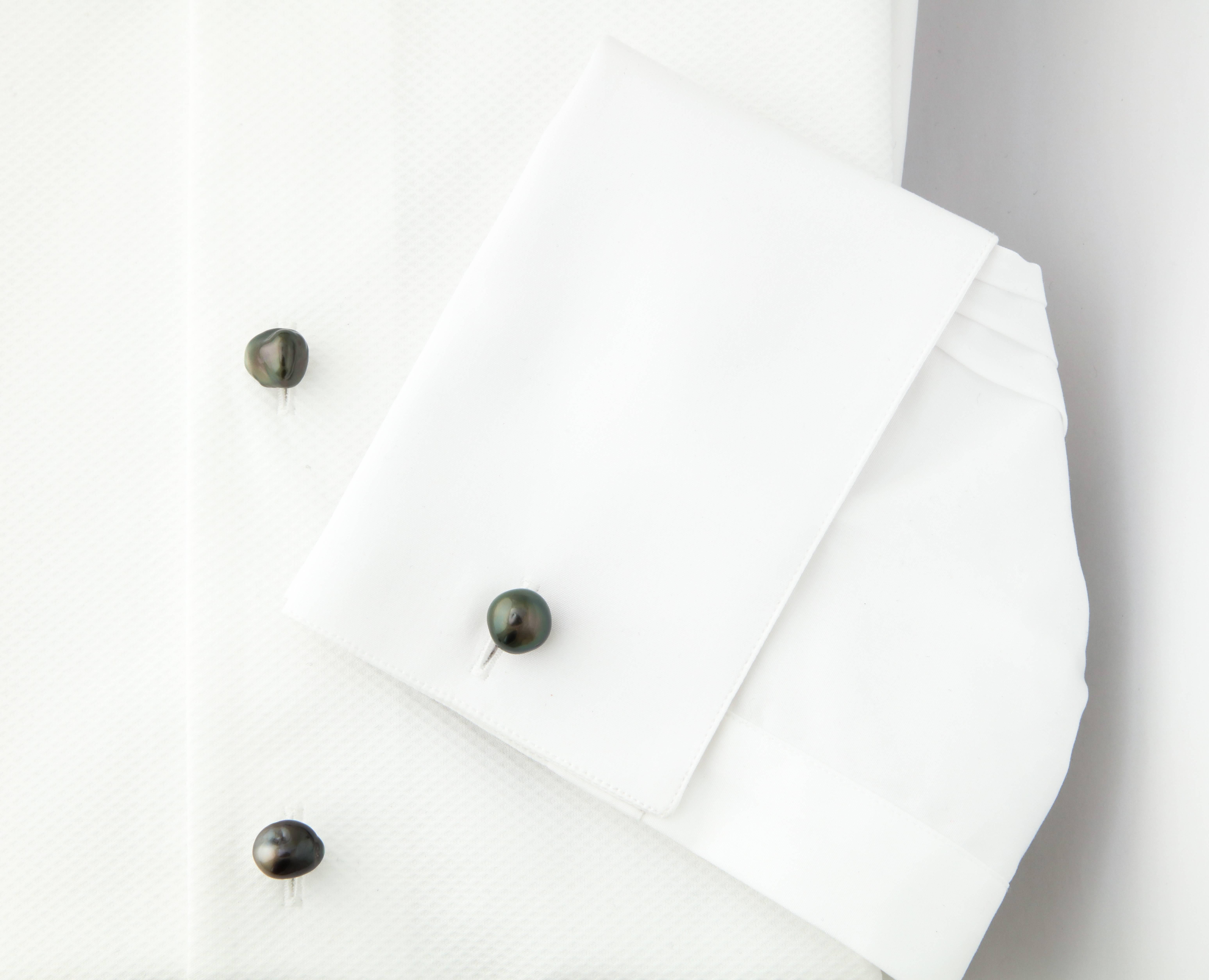 Very fine, and rare, Tahitian, black, keshi pearl dress set.  Expertly mounted in 18kt white gold, each of the settings is made for the individual pearl.  Undoubtedly one of a kind.

Cufflinks designed by Michael Kanners are known the world over