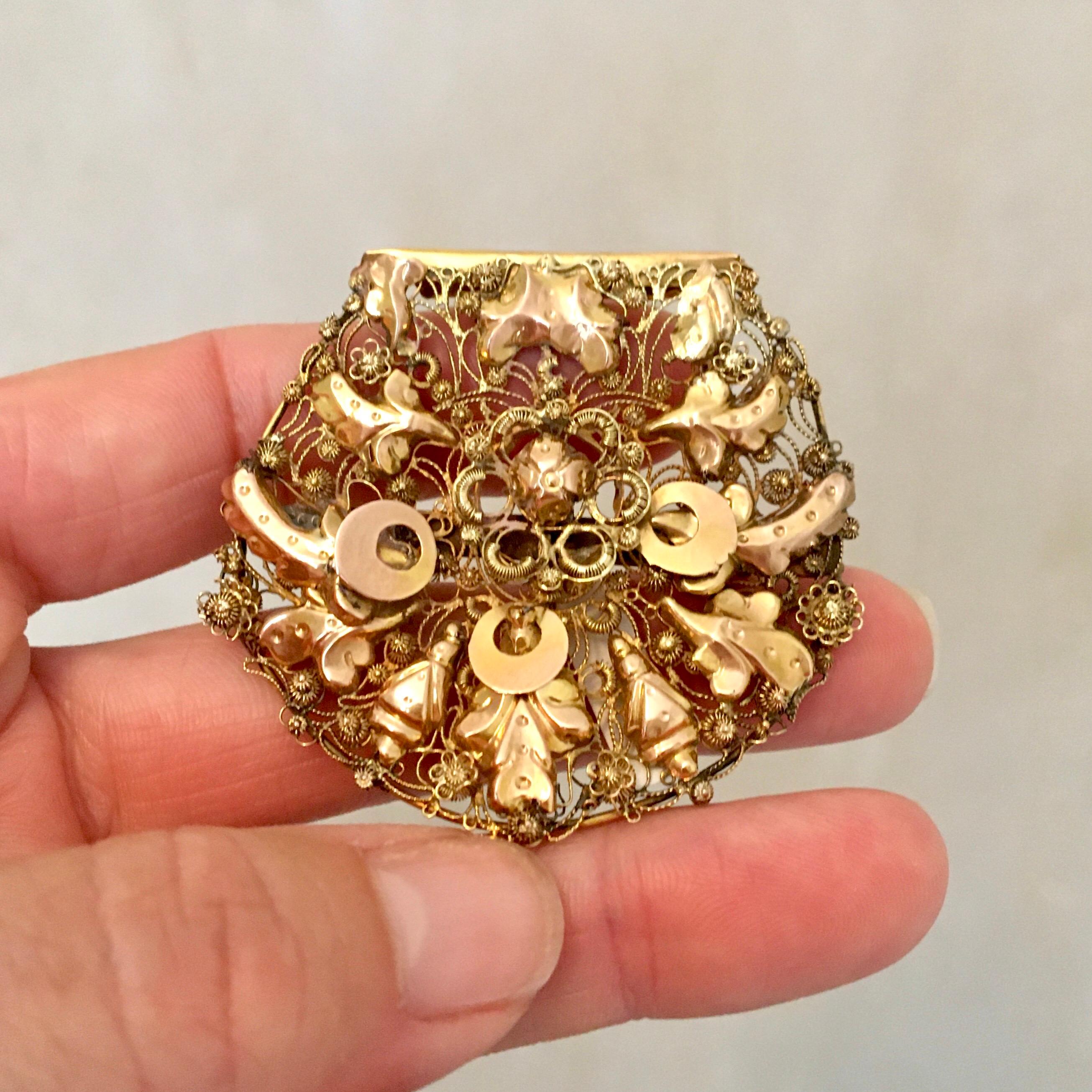 An antique 19th century 14 karat gold brooch created with fine filigree and cannetille work. The brooch is beautifully made, it almost gives the impression of lace or fine embroidery. These types of ornaments were part of the Dutch ear iron. The ear