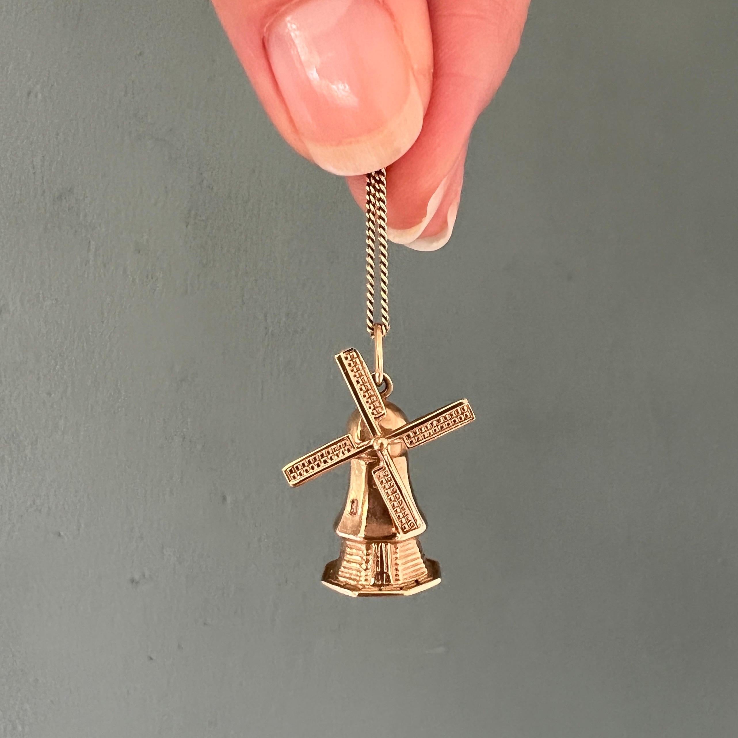 A beautiful and rare vintage large three-dimensional stylized Dutch windmill charm pendant. The octagon windmill is made in 14 karat gold and is nicely detailed with horizontal 'beams' on the hull and windows on the attic floors. The blades of the