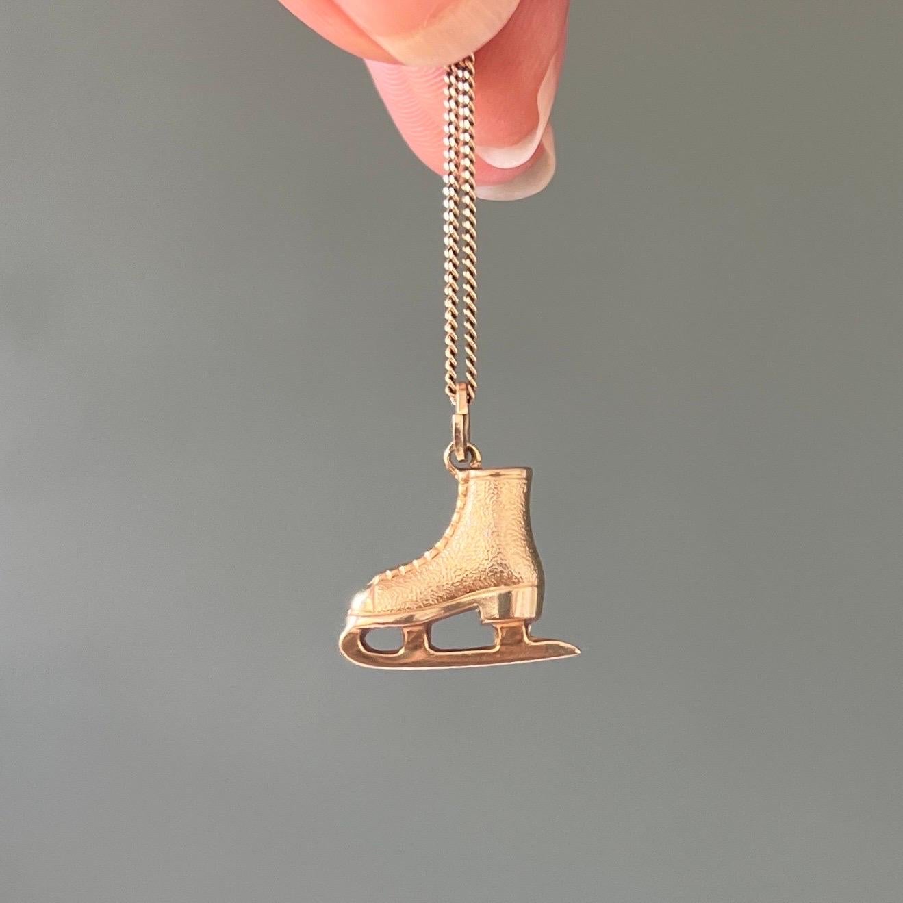 A beautiful vintage stylized figure ice skating shoe charm pendant made in 14 karat gold. The ice skating shoe is nicely detailed with shoelace, blade and heel. The figure skate shoe features a light brushed gold finish. 

The great thing about