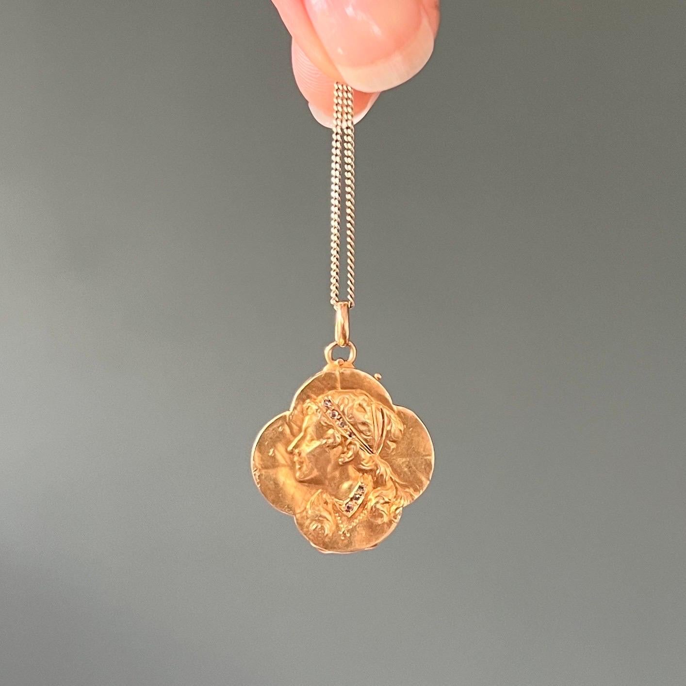 An antique four-leaf clover locket pendant dating back to the Art Nouveau movement, 1890-1914. The beautiful good luck pendant is created in 14 karat yellow gold in the shape of a four-leaf clover, depicting a female portrait in a bass-relief
