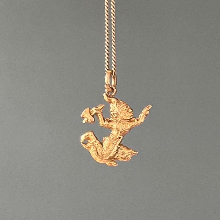 An 18 karat yellow gold Indonesian warrior charm pendant. This lovely preloved vintage charm has great details with the man wearing a traditional gown, head dress and an axe in his right hand. Charms are wonderful as wearable memories and can be