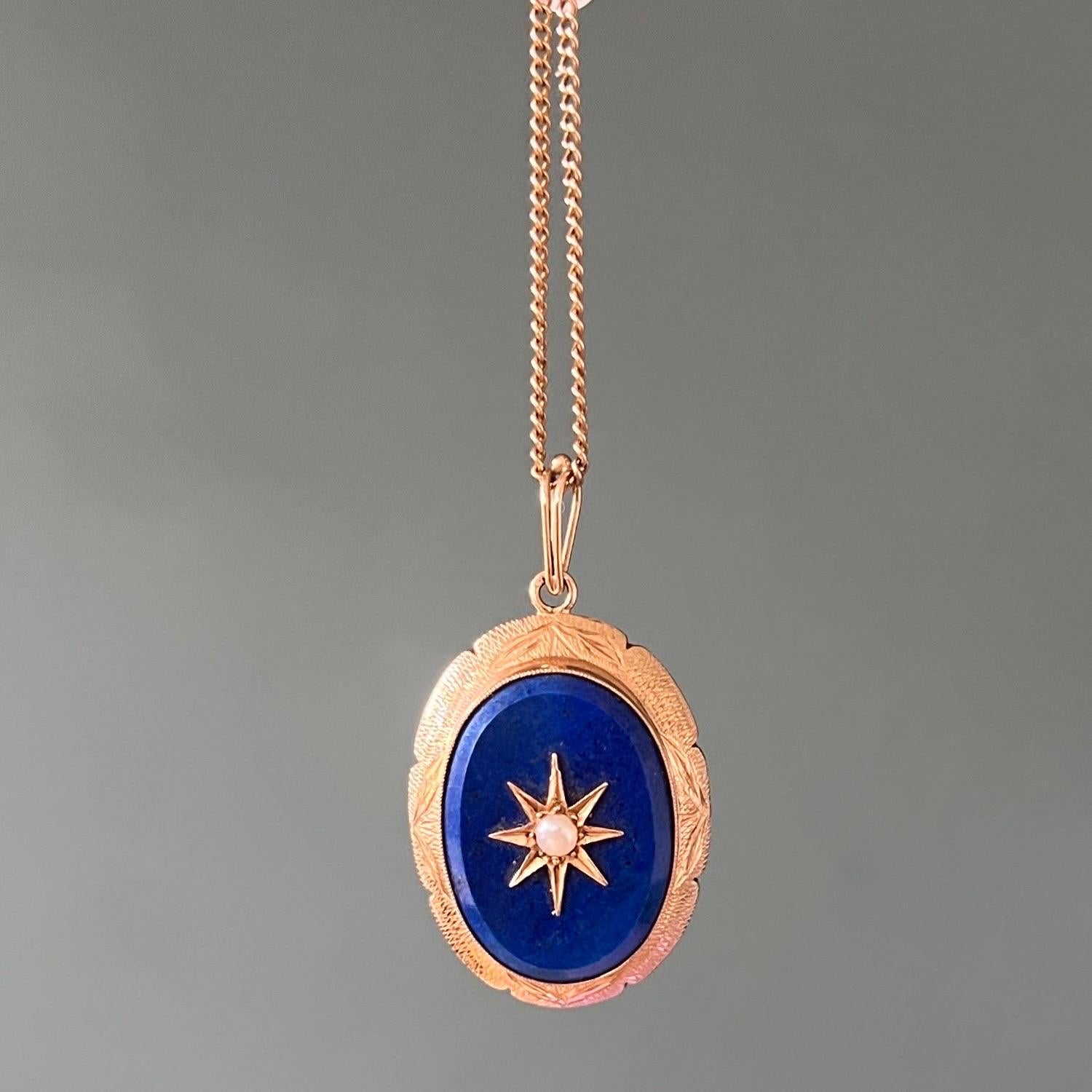 A vintage 14 karat gold oval-shaped pendant set with a lapis lazuli gemstone. A cultured pearl is placed in a gold star in the center. The lapis lazuli is smoothly polished and has a beautiful blue hue. The gold eight-pointed star represents a