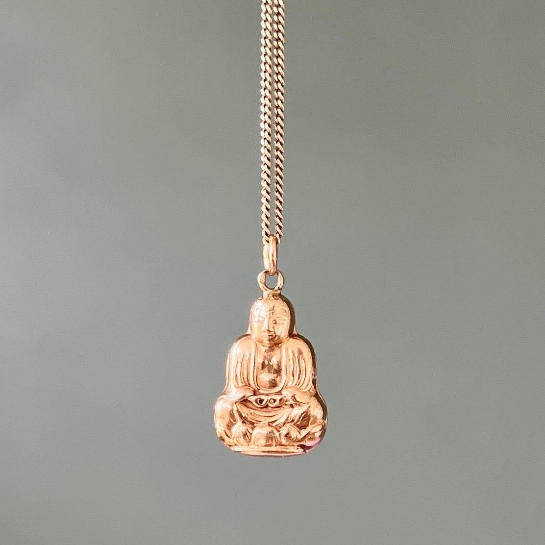 A vintage seated buddha charm pendant created in 14 karat gold. The gold buddha is beautifully detailed and is wearing a robe over his shoulders. The body of the buddha is detailed with raised work. The charms comes without the chain.

Collect your