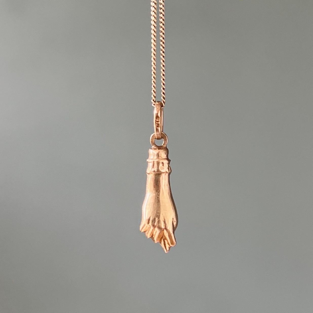 A mano figa hand charm pendant created in 14 karat gold. The cuff of the arm has beautiful details. This charm is great worn alone or layered with your other favorite beauties. The charm comes without the chain.

The figa hand symbol dates back