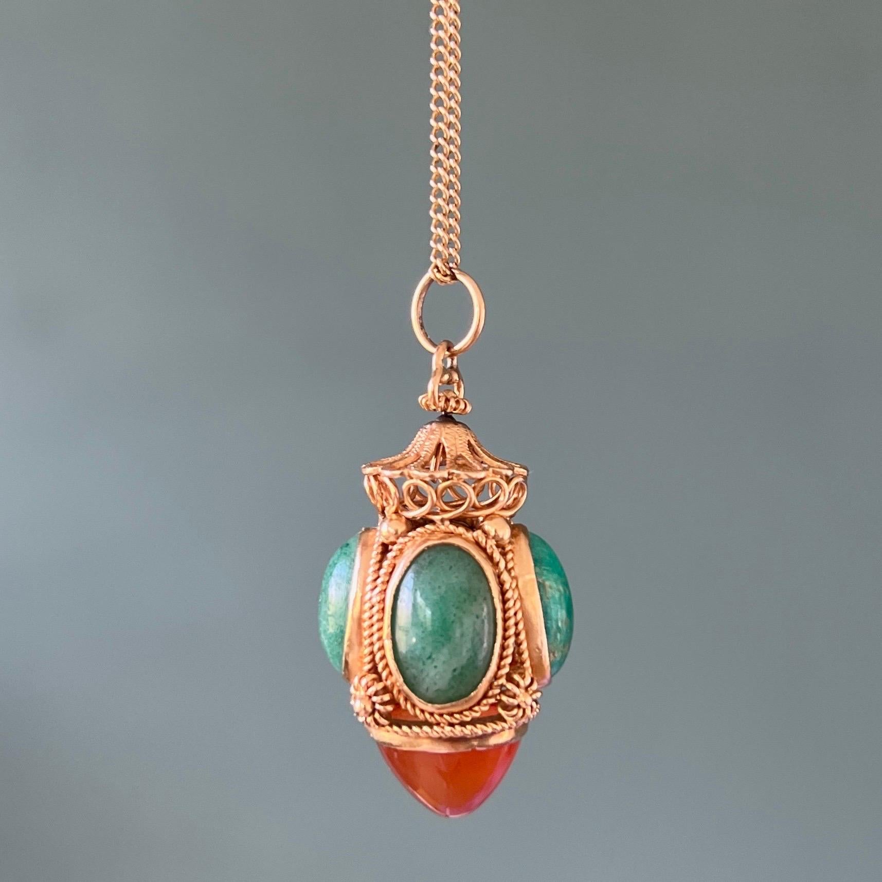 Beautiful large 18 karat gold Venetian Revival style lantern pendant. The pendant is set with four colorful opaque cabochon cut oval green amazonite gemstones and a large cone shaped translucent carnelian gemstone at the bottom. The gold surface is