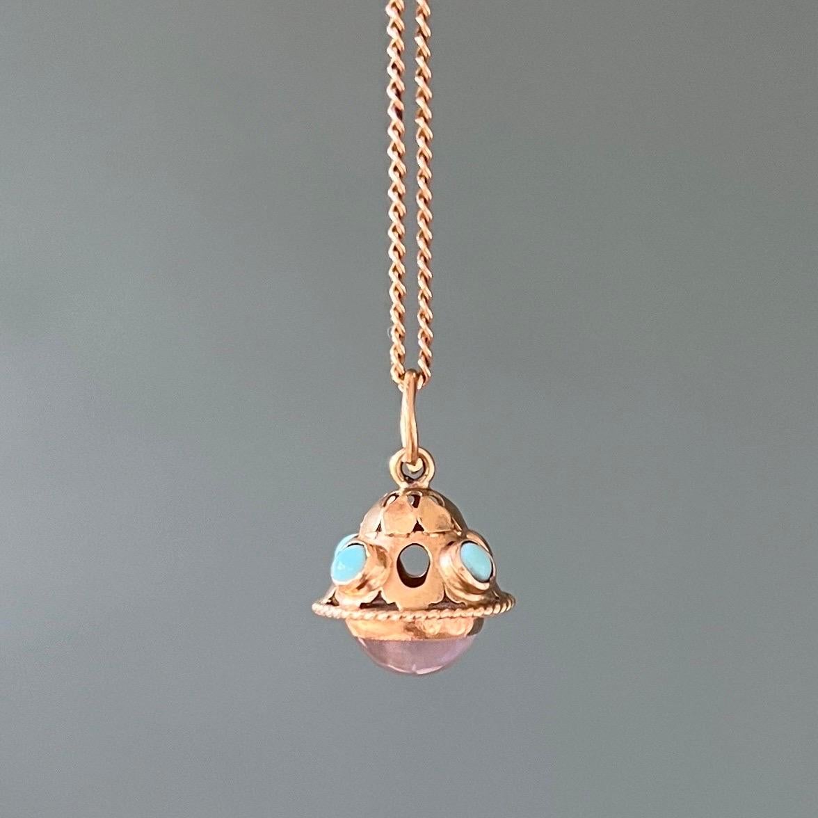 A vintage 18 karat yellow gold and turquoise charm pendant. The charm is nicely crafted and set with four turquoise stones around the upper body. At the bottom the charm is set with a moonstone cabochon stone, which is translucent and has a lovely