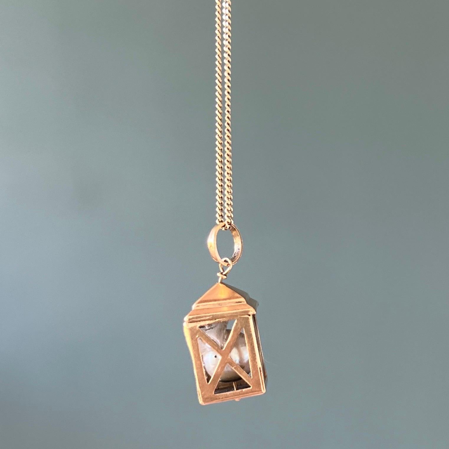 A vintage 18 karat yellow gold Italian lantern charm pendant. This vintage lantern has some great details. The cage has openwork detailing with a synthetic pearl inside the lantern. The top of the lantern has a closed lid.

Collect your own charms
