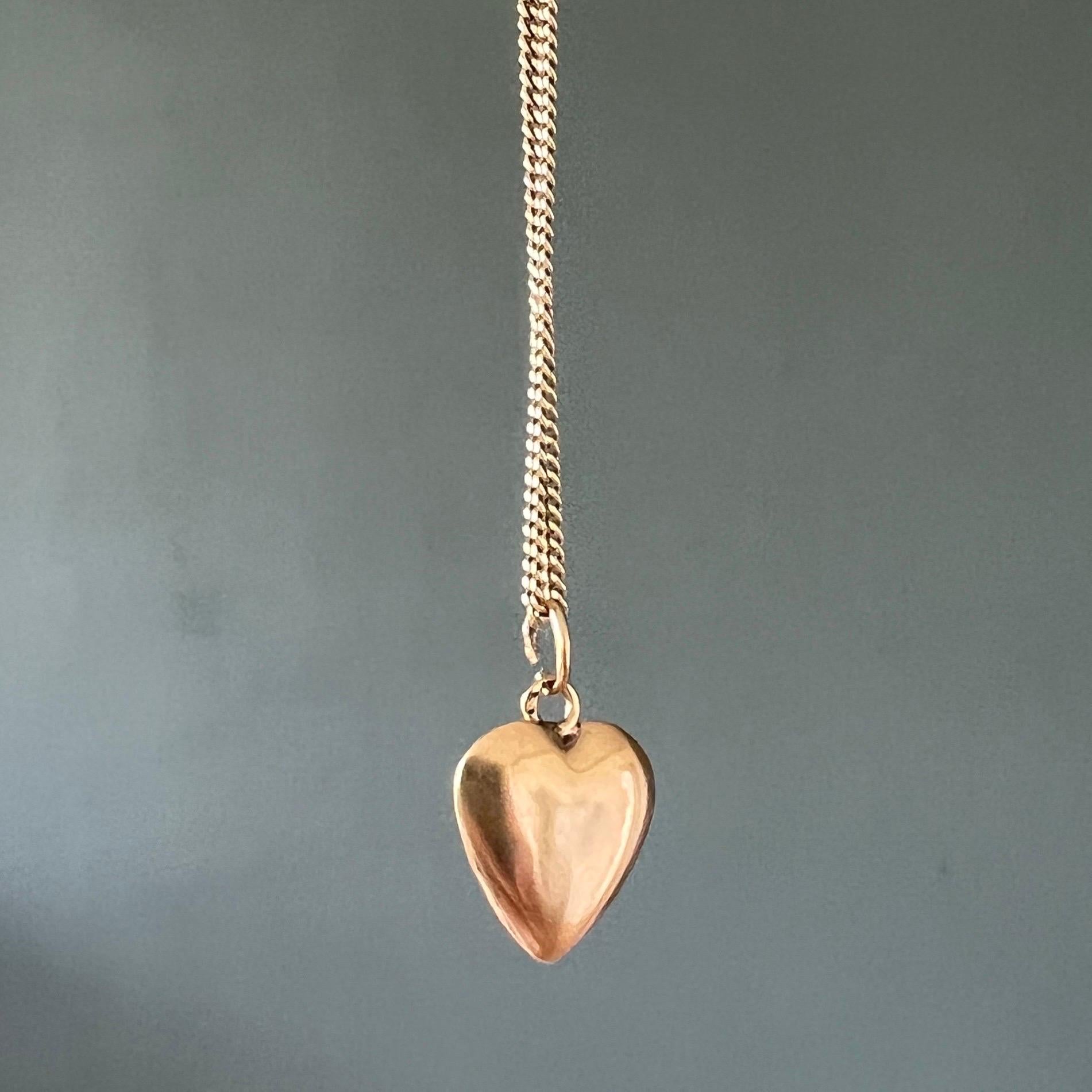A 14 karat yellow gold vintage lovely heart charm pendant. The surface of this gold heart charm is smooth and polished on each side. 

Collect your own charms as wearable memories, it has a symbolic and often a sentimental value. This beautiful
