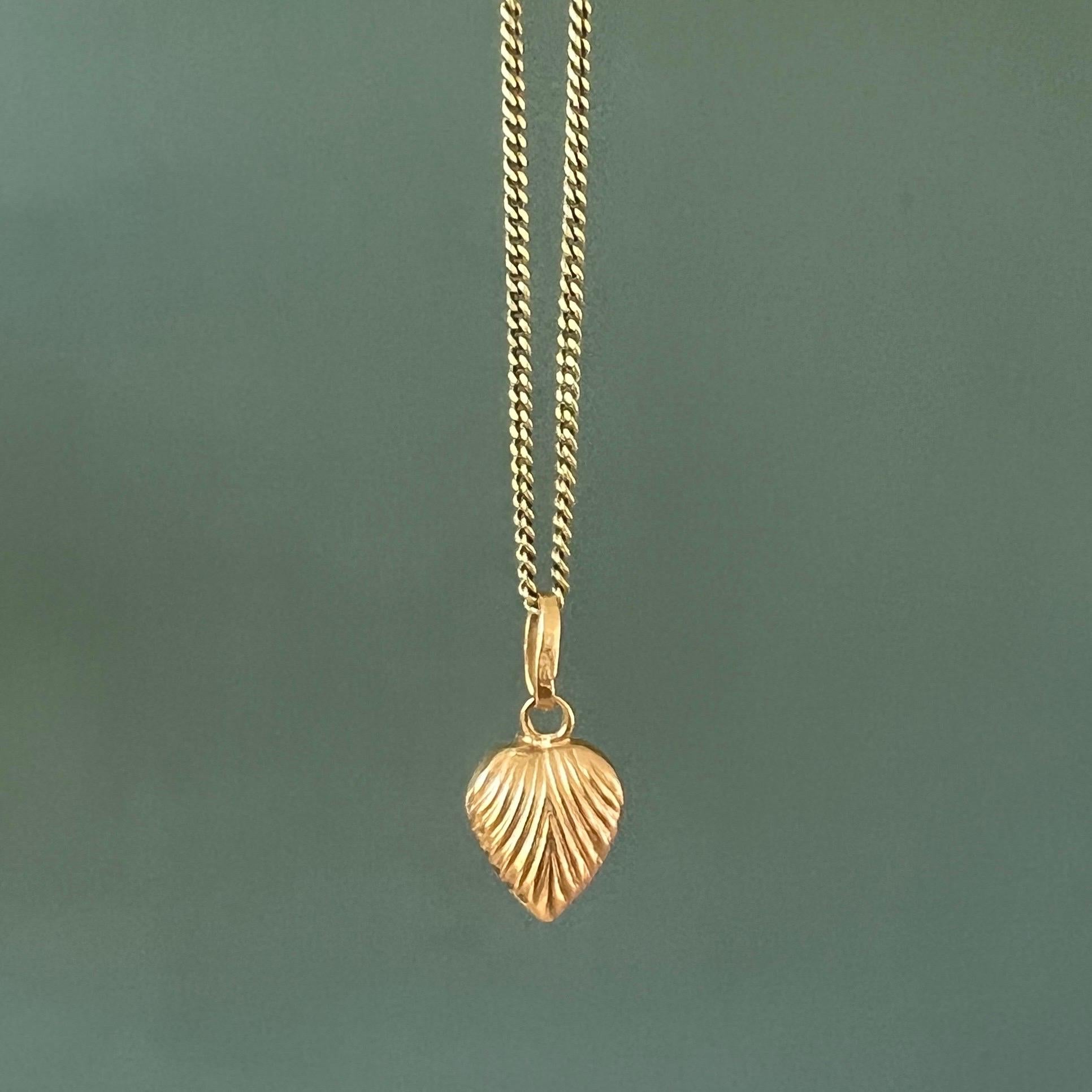 A vintage gold engraved sunburst heart charm pendant. The sunburst heart charm is beautifully designed and made in 18 karat gold. Charms are great to collect as wearable memories, it has a symbolic and often a sentimental value. They can be added to
