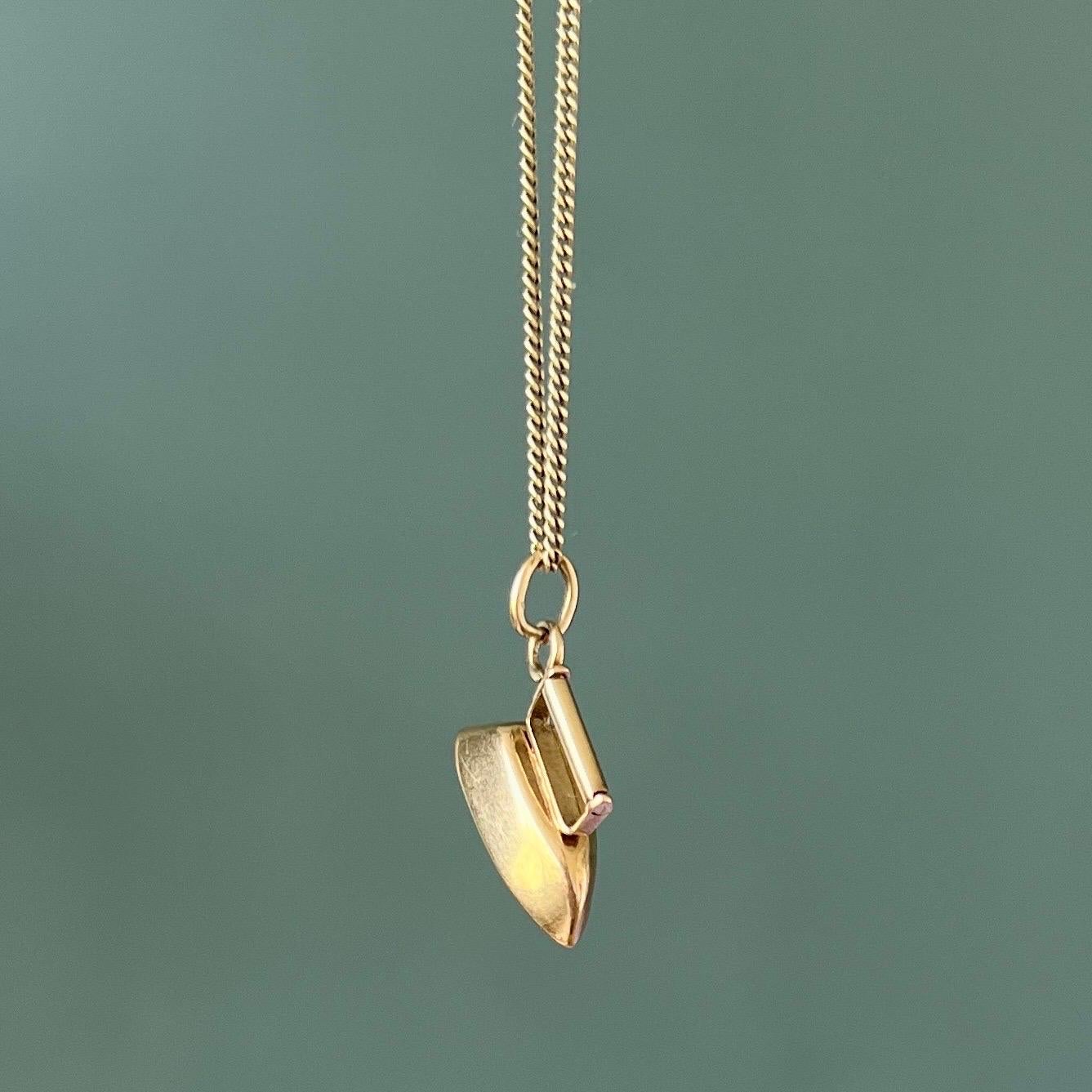 A lovely vintage gold flatiron charm pendant. This household appliance is nicely designed with rotatable handle. The charm is created in 14 karat yellow gold. Charms are great to collect as wearable memories, it has a symbolic and often a