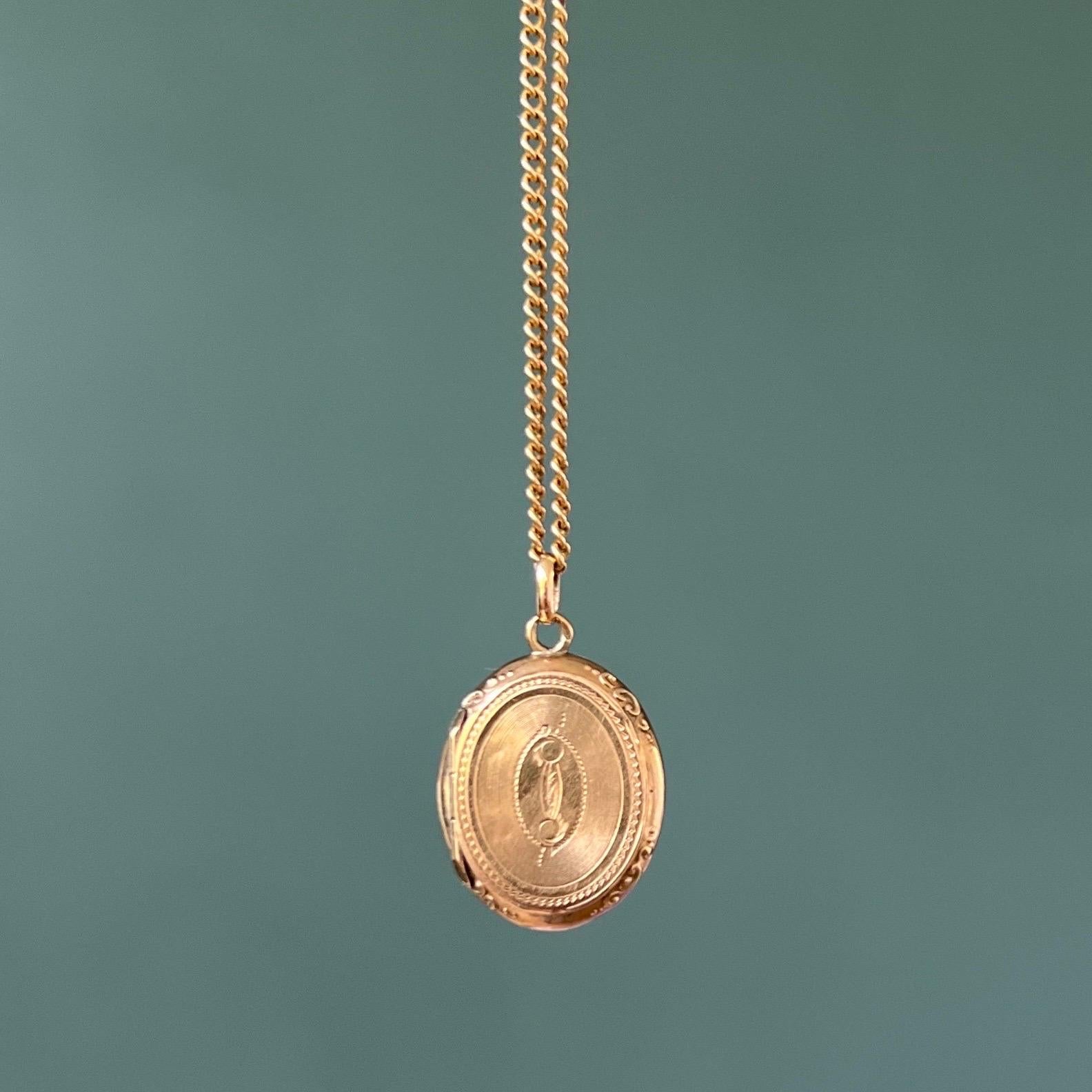 This antique Victorian mourning locket pendant was once worn close to someones heart. The locket pendant dates back to the 19th century and is created in 14 karat gold. The front and back of this oval-shaped pendant is beautifully engraved with