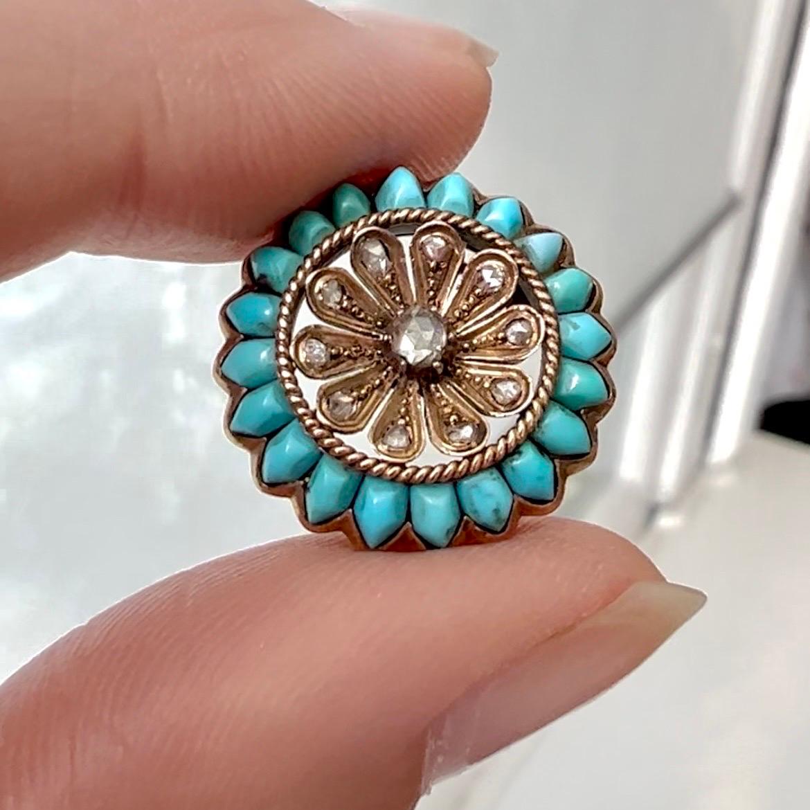 So beautiful! An antique Victorian flower brooch pin set with rose cut diamonds and turquoise cabochon stones. The eleven rose cut diamonds - which are reminiscent of seeds - are haloed by twenty lovely turquoise petals. The antique gold brooch is