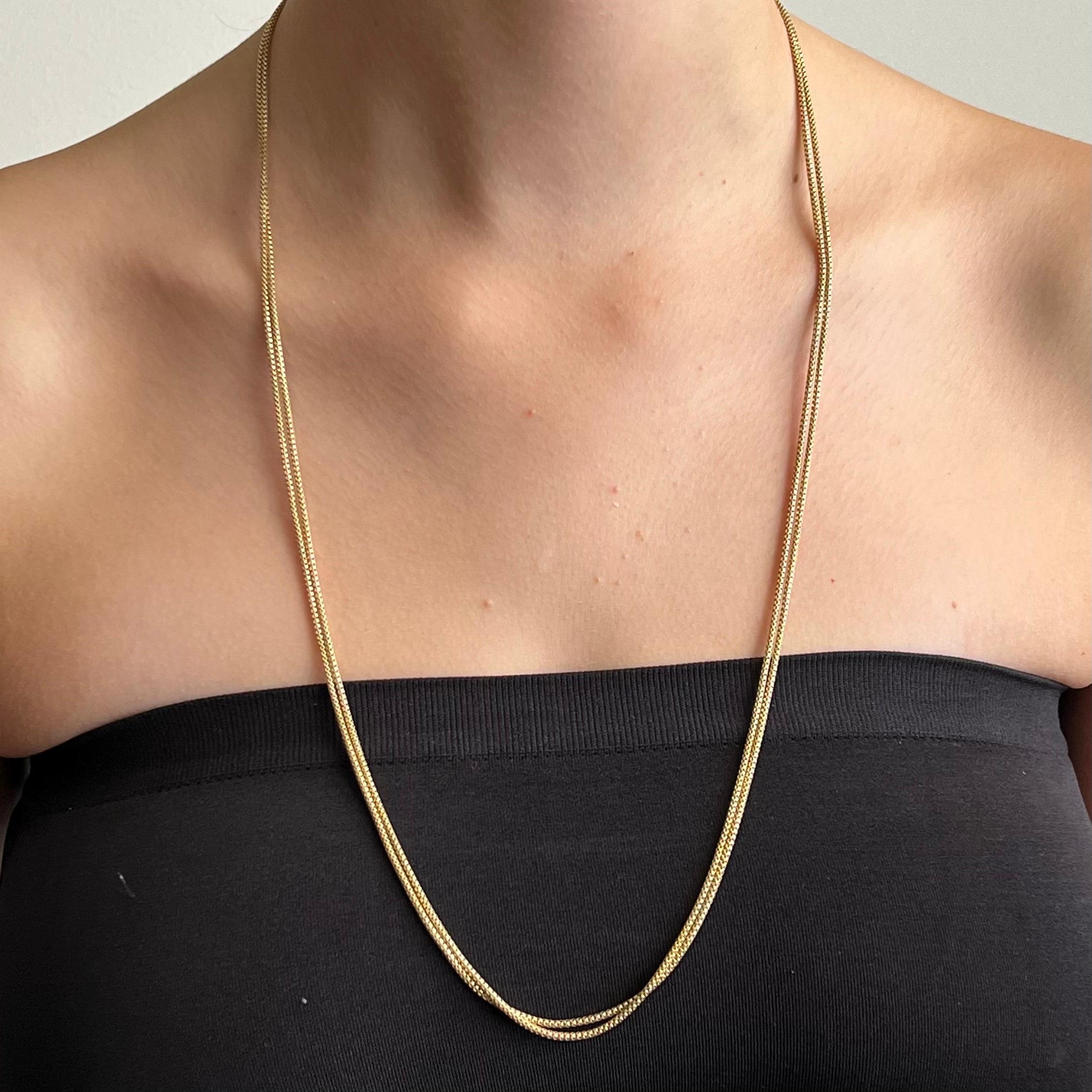 A sautoir box chain necklace made of 14 karat gold. The box chain is also called a 