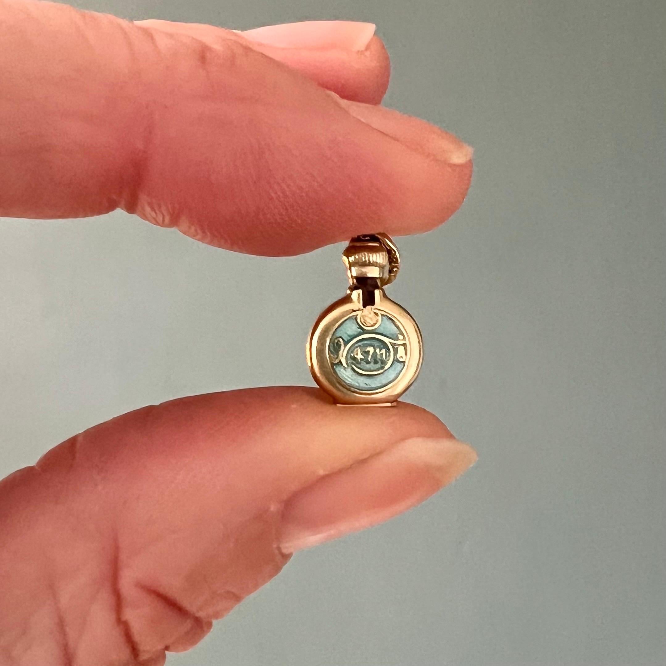 This is a 14 karat yellow gold vintage eau de cologne 4711 bottle charm pendant. 4711 is an aromatic citrus fragrance for women and men. The charm is beautifully crafted in gold and turquoise enamel.

Fun fact, the name 4711 refers to the house
