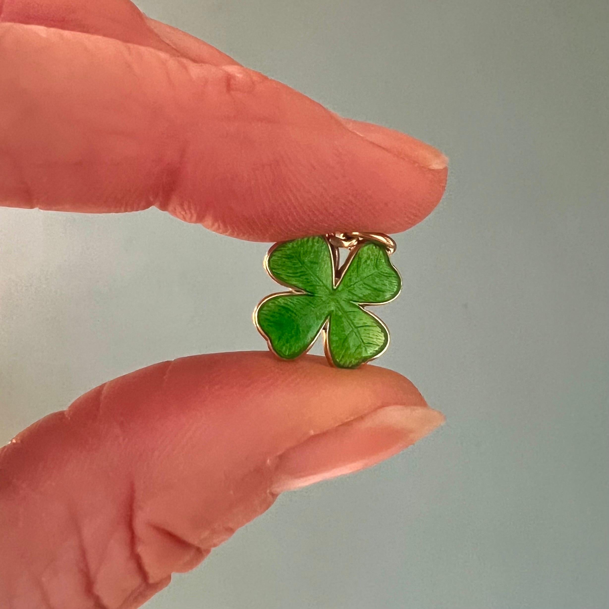 This is a 14 karat yellow gold enameled four clover leaf charm pendant. This lovely good luck pendant has a beautiful green enamel layer on top with a polished gold back and bail. 

Charms are great to collect as wearable memories, it has a symbolic