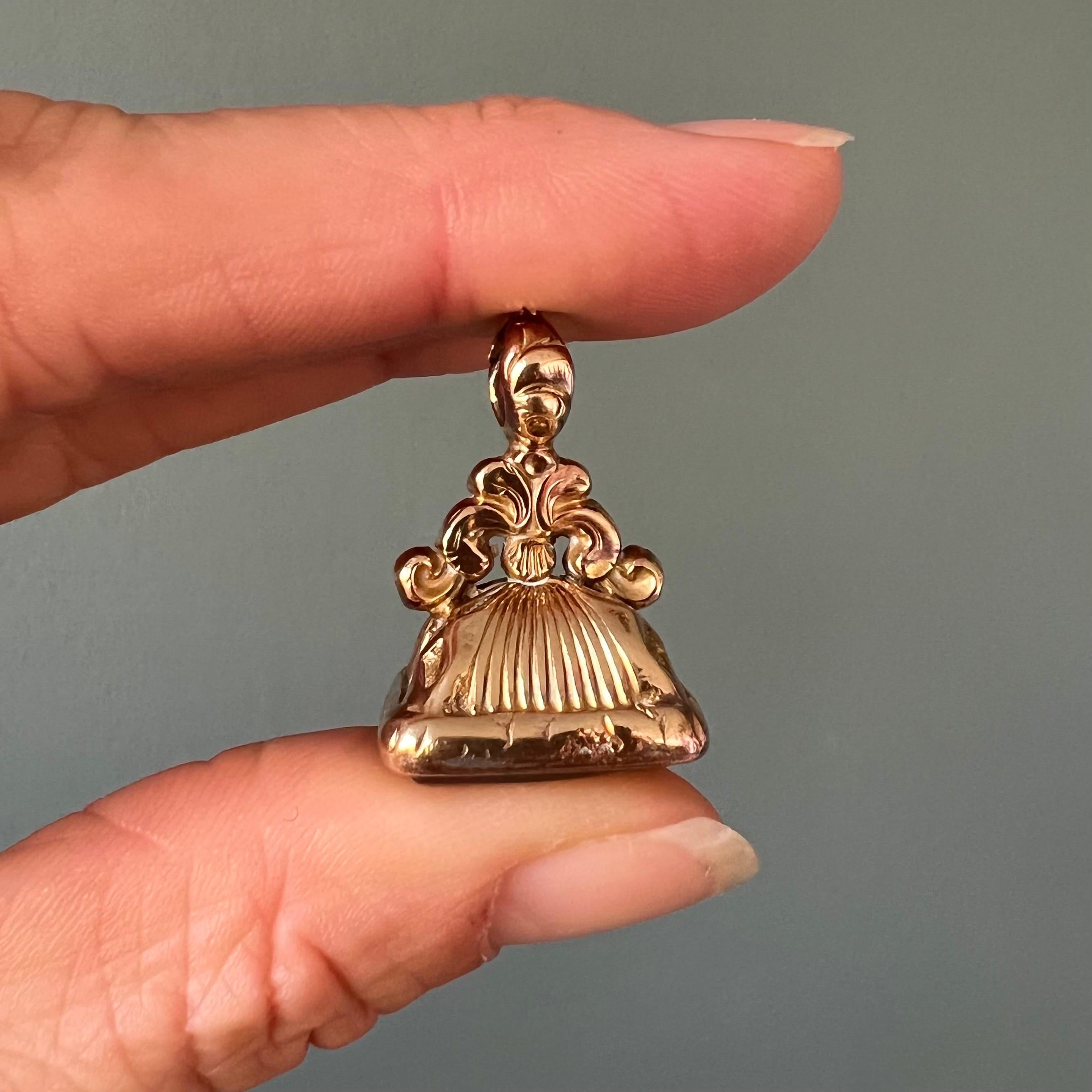 Questo raffinato pendente a forma di fob antico è caratterizzato da una pietra di cristallo di rocca liscia e levigata incastonata alla base, che offre un'eleganza chiara e raffinata. Lo strato superiore del bracciale è meticolosamente inciso in