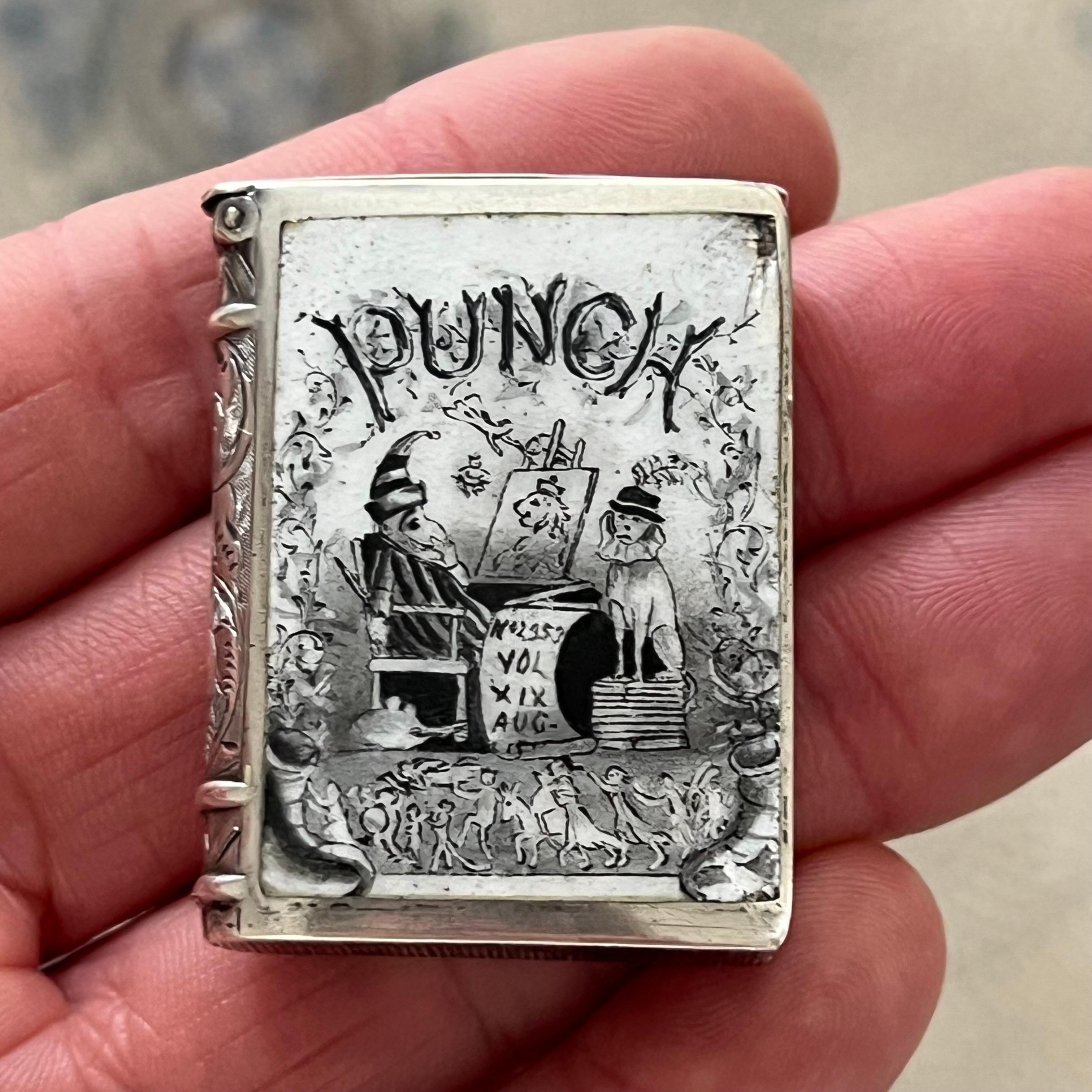 An exceptional example of Victorian whimsy and craftsmanship, this antique silver vesta case is both a functional object and a collector’s delight. Designed in the form of a miniature book, the case is exquisitely decorated with a hand-enameled