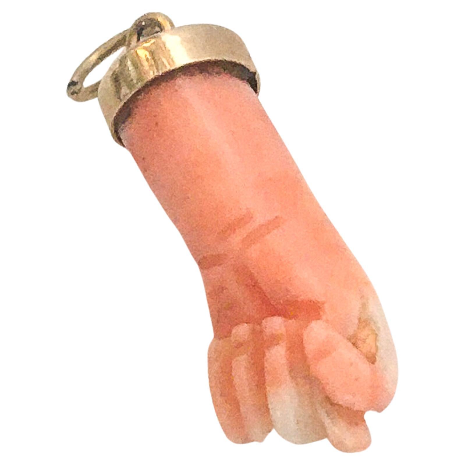 A vintage coral figa hand charm set with a 14 karat gold bail. The hand has beautiful engraved details. The charm is great worn alone or layered with your other favorites. The charm comes without the necklace. 

The figa hand symbol dates back