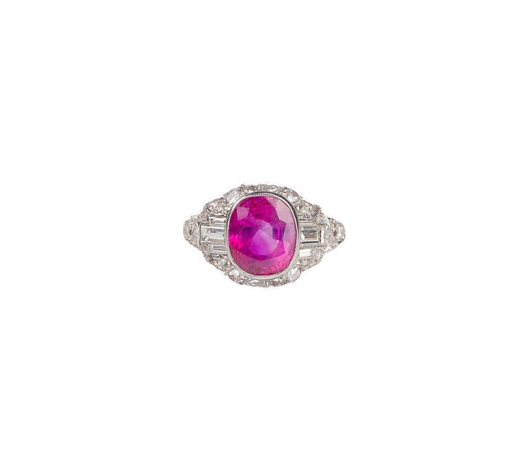 Extraordinary ring centering a bezel-set Burmese non-heat treated ruby in an intricate diamond-set mounting. Ruby has certificate from Gemological Institute of America (GIA) weight 4.20 carats, color: purplish-red with strong saturation, total