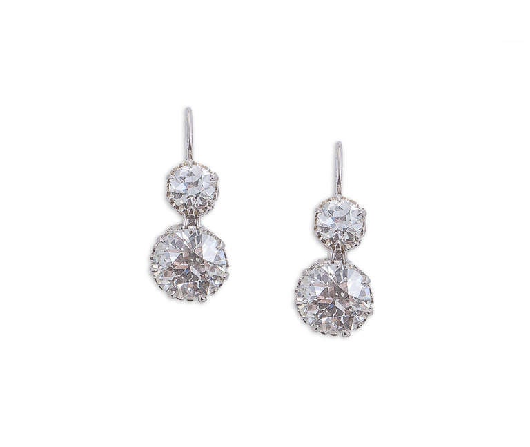 Platinum and diamond 2-stone earrings accompanied by 4 European Gemological Laboratory (EGL) certificates. 4 European-cut diamonds: 2.57 carats - color: J - clarity: VS1;  2.51 carats - color: J - clarity: VS1; .72 carats - color: I - clarity: VS1;