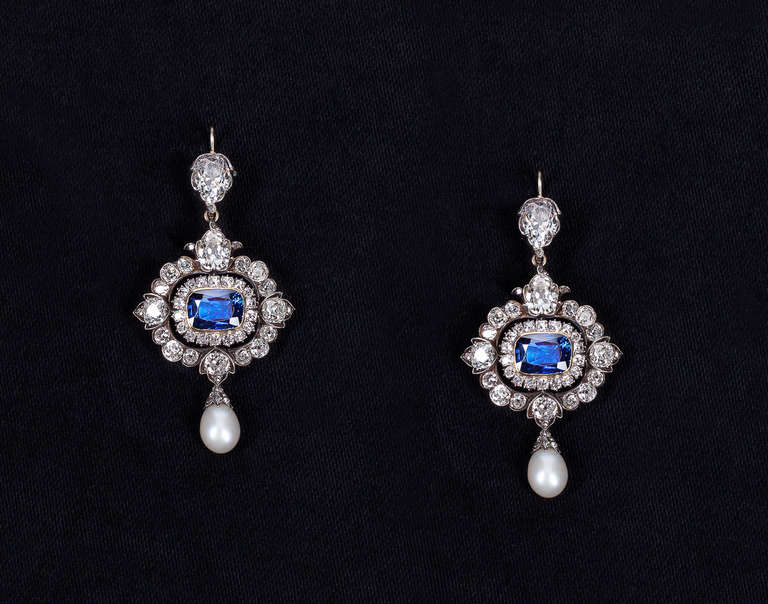 Exquisite Victorian pendant earrings, all original. Each earring is backed in 15 karat gold, topped in silver and centers 1 NON-HEAT TREATED (with AGL certificates) sapphire surrounded by old mine-cut, old European-cut, single-cut, cushion-cut and