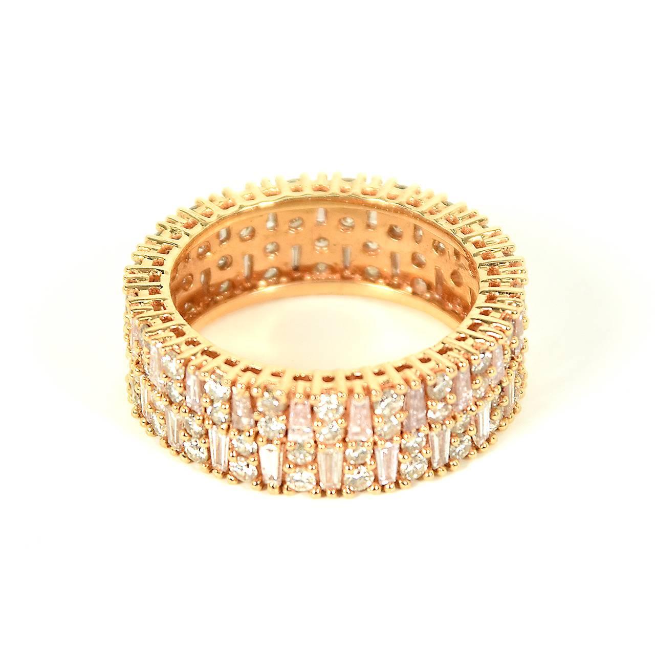 18ct rose gold eternity ring, diamond-set full circle band, individually micro-claw set with a total of 42 tapered baguette diamonds of a faint blush pink hue, alternating with sets of two brilliant cut diamond in a staggered pattern around the