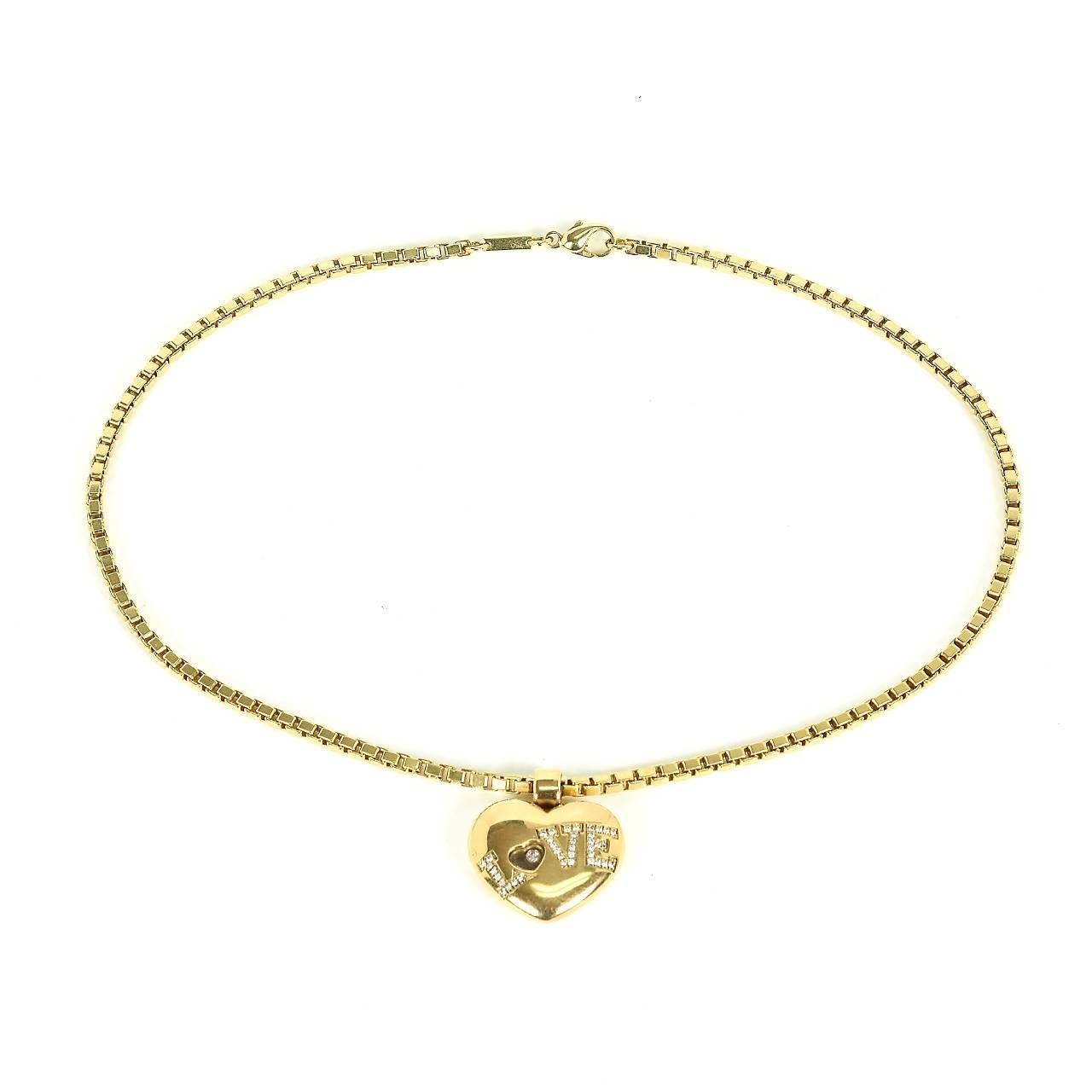 18ct yellow gold Chopard box link necklet featuring Love Heart pendant set with 39 brilliant diamonds to form the word 'LOVE'.  Pendant contains the hallmark Happy Floating Diamond. Chain is also marked 'Chopard' near the clasp. Heart pendant is