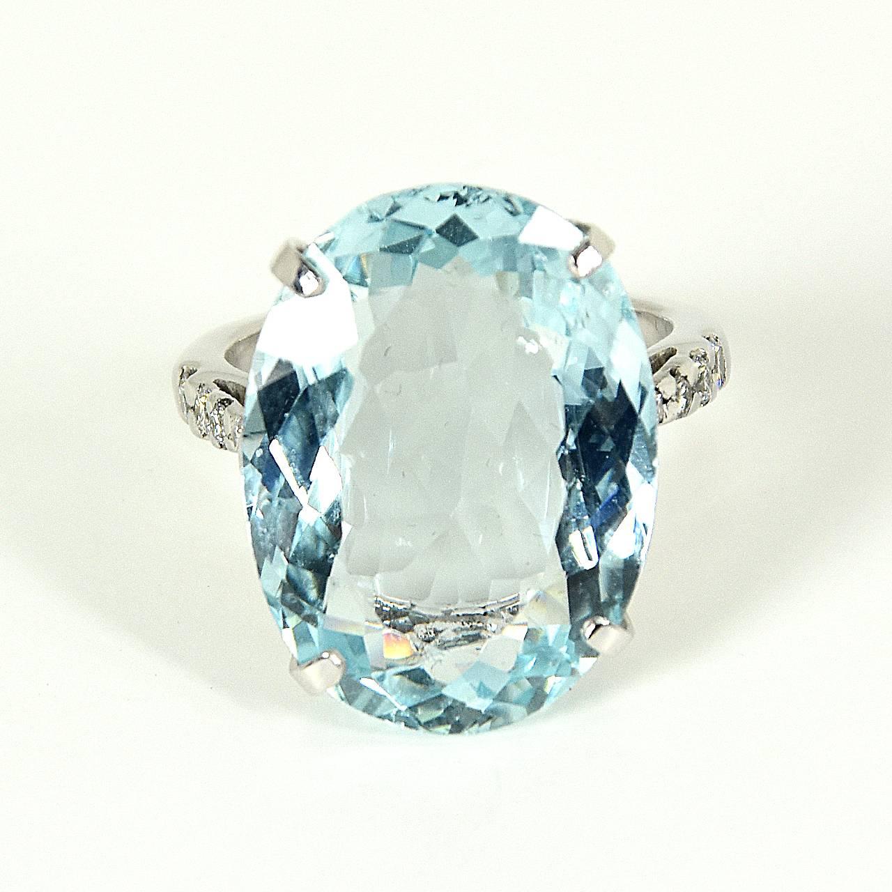 An 18ct White Gold ring, featuring an oval, chequerboar- faceted 14.95ct aquamarine with diamond-set shoulders. 
aquamarine dimensions: 21.8mm x 16.1mm x 7.4mm
approximate total weight: 10.8 grams 
Ring size: American - 7, French/Japanese - 14,