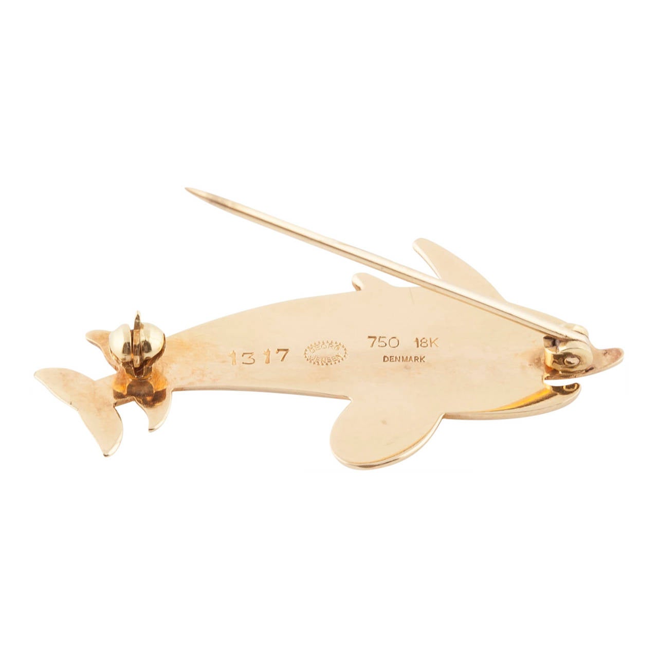 A rare 18ct yellow gold brooch of double leaping dolphins, designed by Arno Malinowski for George Jensen Jewellery. This design is no longer in production. Gold Jensen is also very rare and therefore sought after. It is fastened with a hinged pin