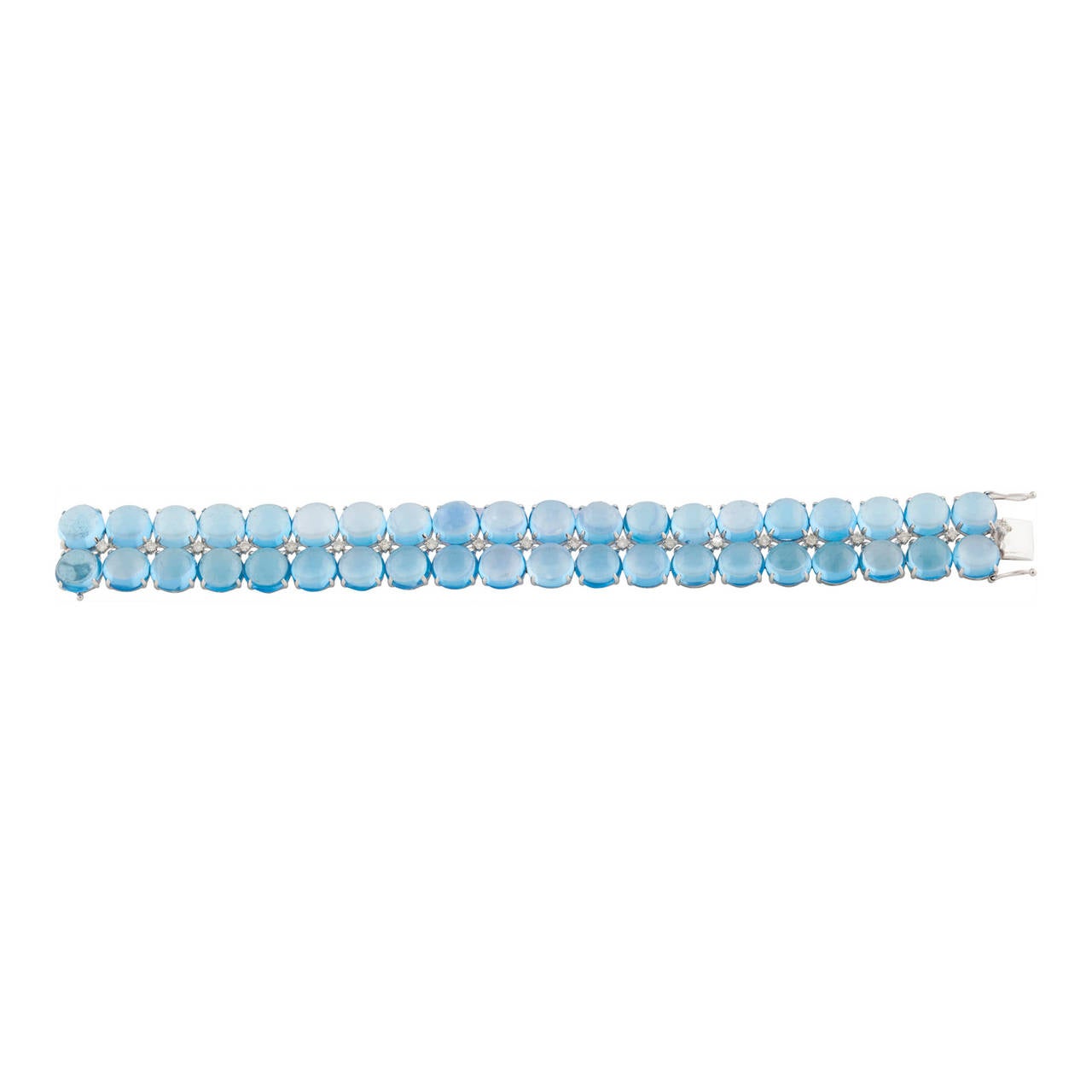 A superb 18ct white gold bracelet with 40 round cabochon cut Blue Topaz, claw set intercepted by 20 round brilliant-cut diamonds.
Estimated total weight of blue topaz: 121.49ct
Estimated total weight of diamonds: 0.62ct
Total weight of bracelet: