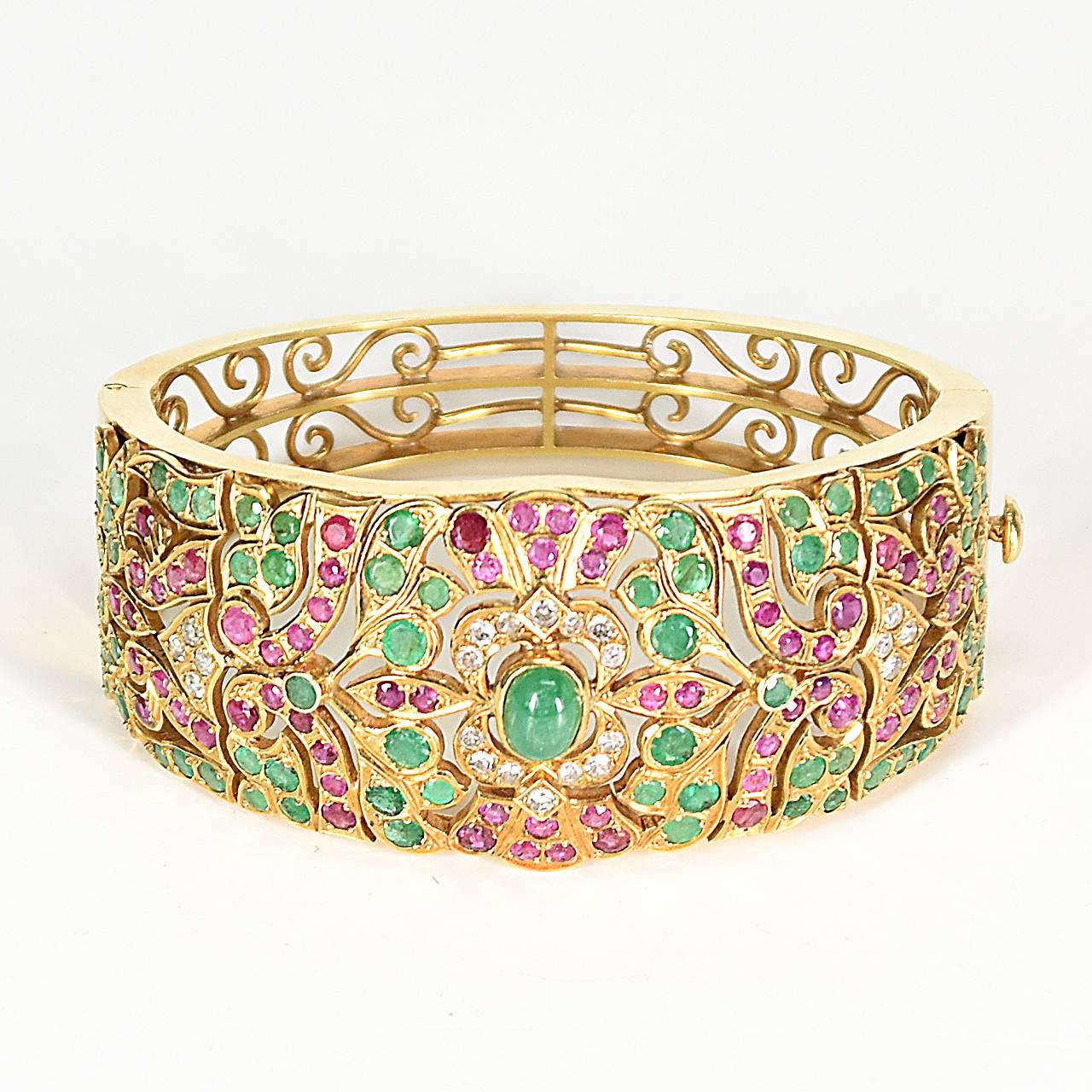 Anglo Indian Detailed18ct Yellow Gold Bangle design studded set with 71 emeralds, 73 rubies & 22 diamonds in an intricately pierced Arabesque style.
Circa 1920's
Independent valuation in Australian dollars

