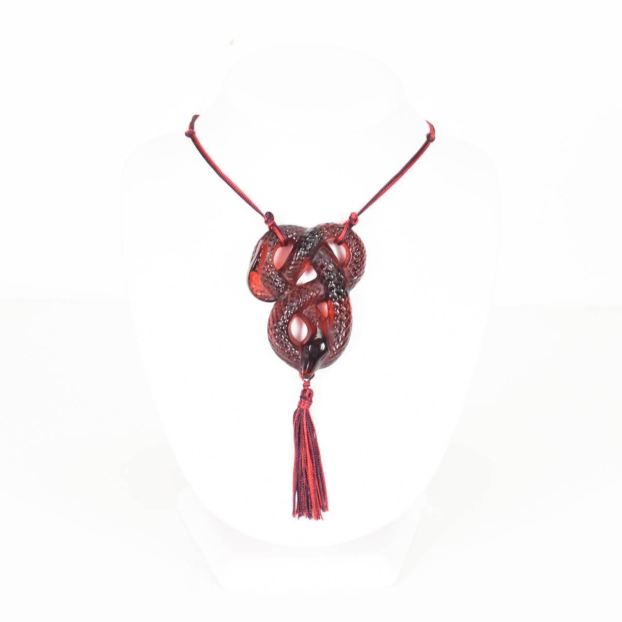 Modern Lalique Art Deco-Style
Serpent Pendant Necklace
in deep crimson red glass
suspended on a matching silk cord presented in original Lalique box with accompanying certificate
NB this item is no longer in production