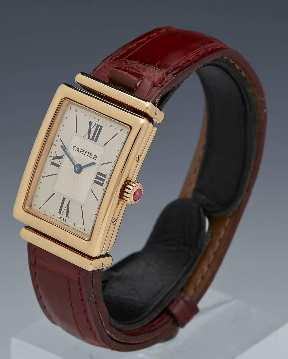 Ref 	COM043
Condition 	9 - Excellent condition
Gender 	Ladies
Age 	1990's
Case Size 	24mm by 30mm
Box & Papers 	Cartier Box
Movement 	Mechanical Manual Wind
Case 	18k Yellow Gold
Dial 	Silver with Black Roman Numerals
Bracelet 	Burgandy